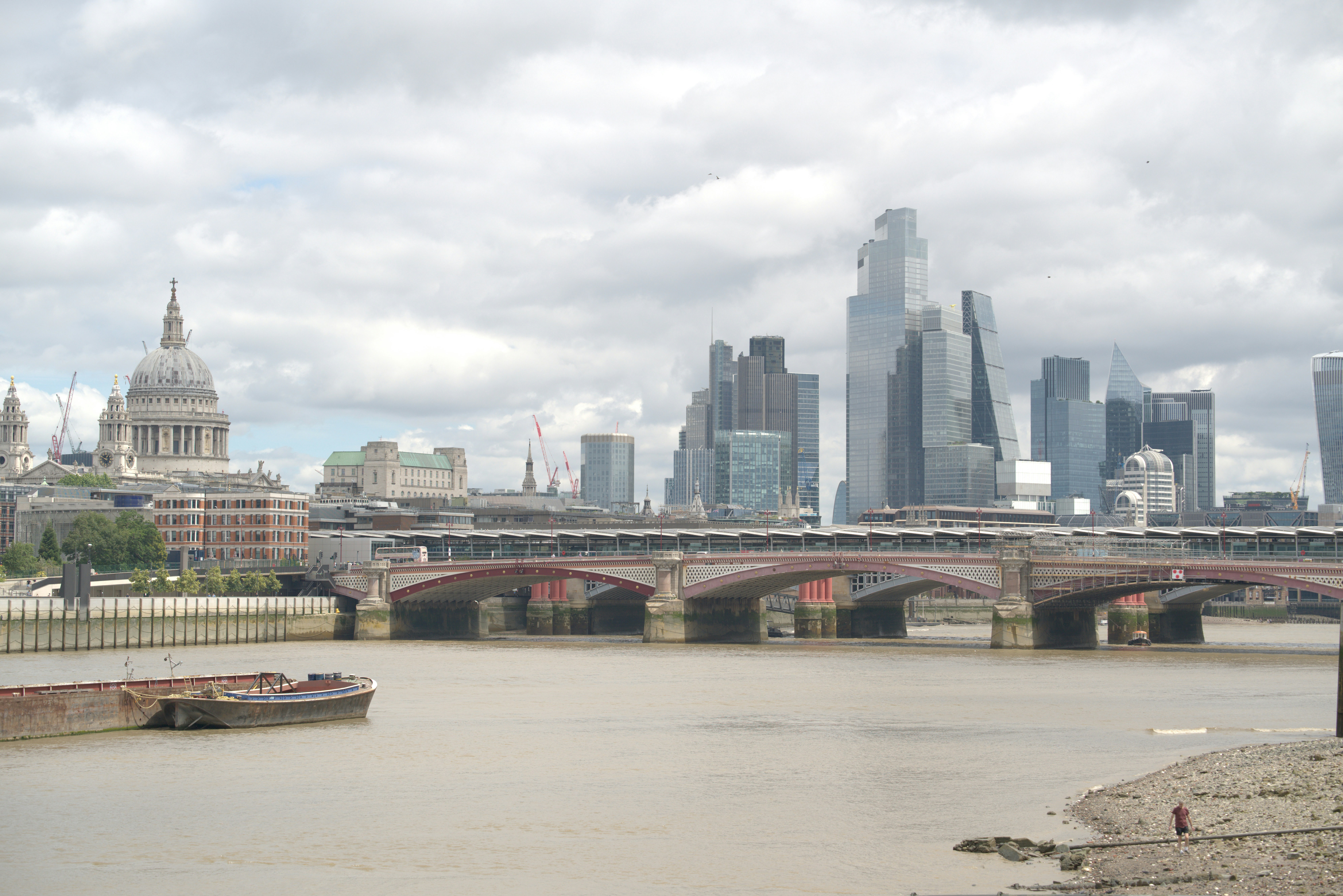 Cityscape of london with st. paul's cathedral, bridge, and river.
