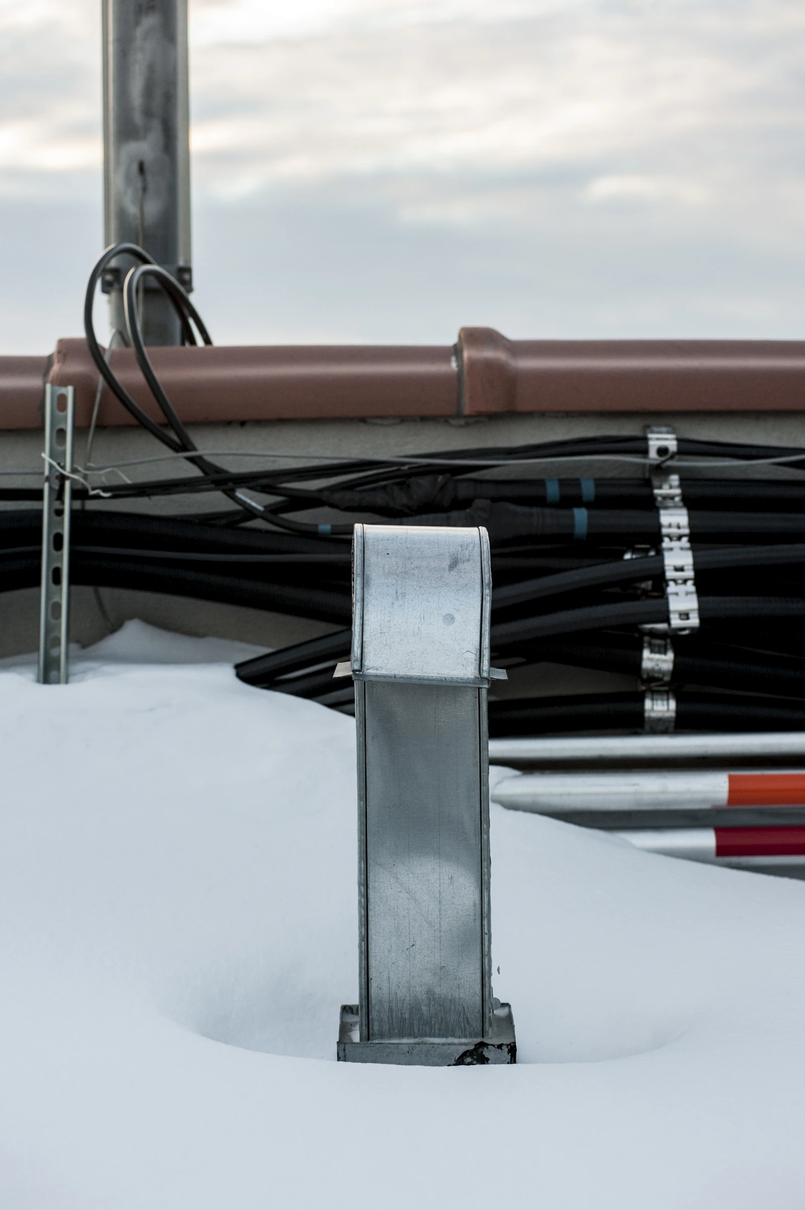Roof ventilation components on a snowy Lake Zurich, IL rooftop in winter