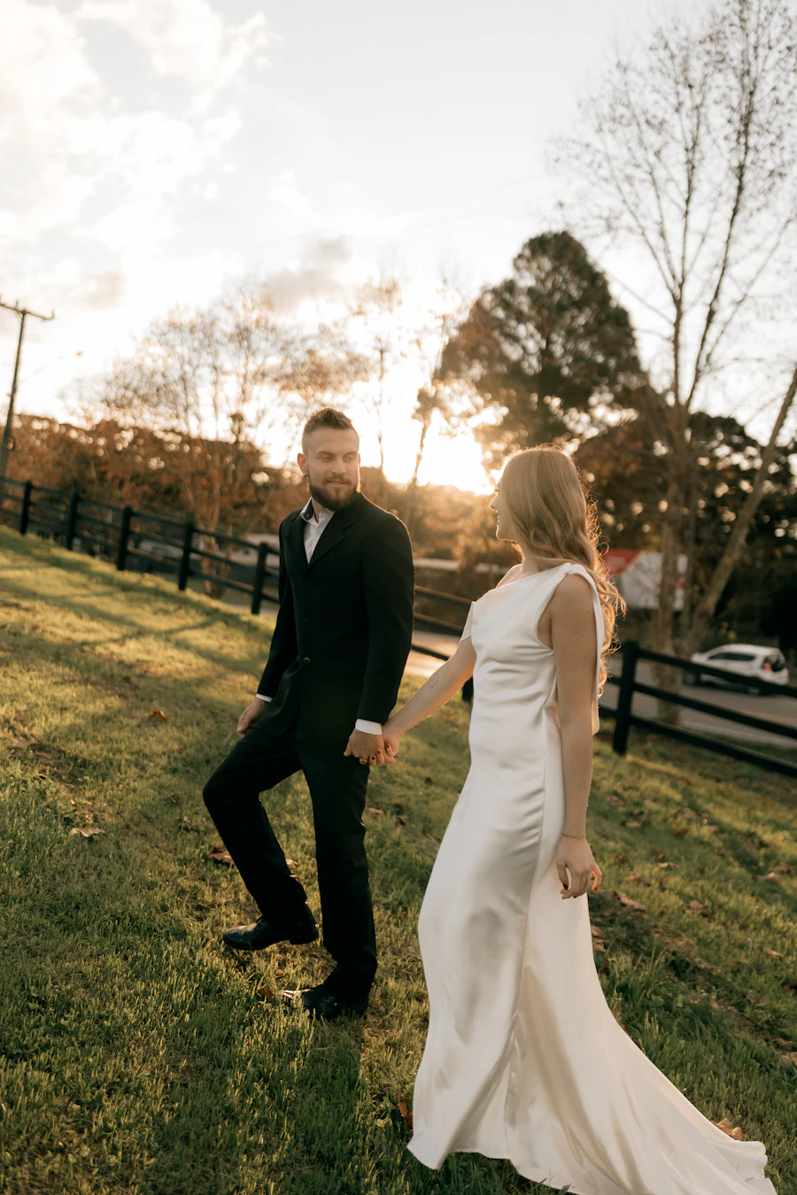 Couple walking up a grassy hill