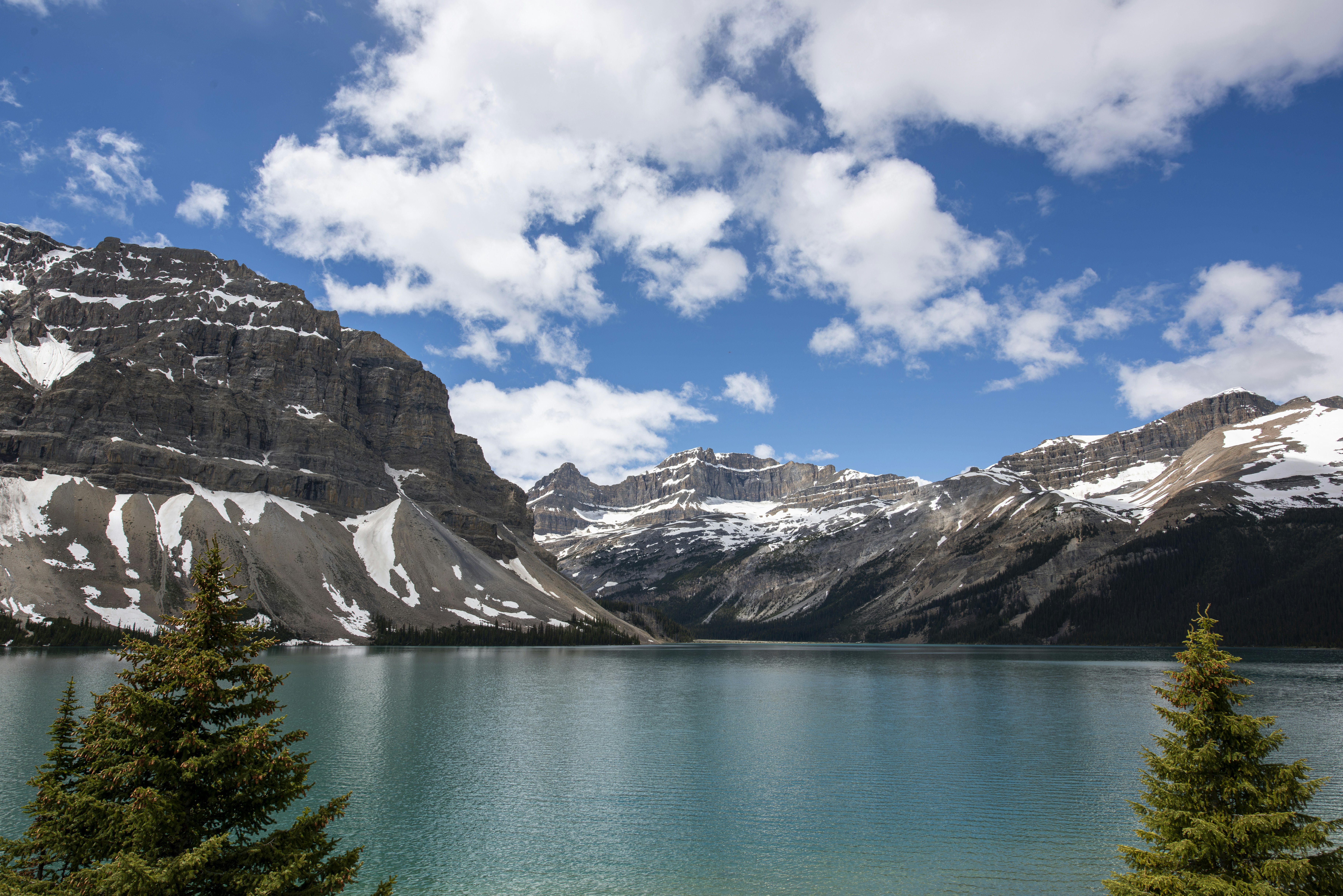 Scenic mountain lake with snow-capped peaks and blue sky