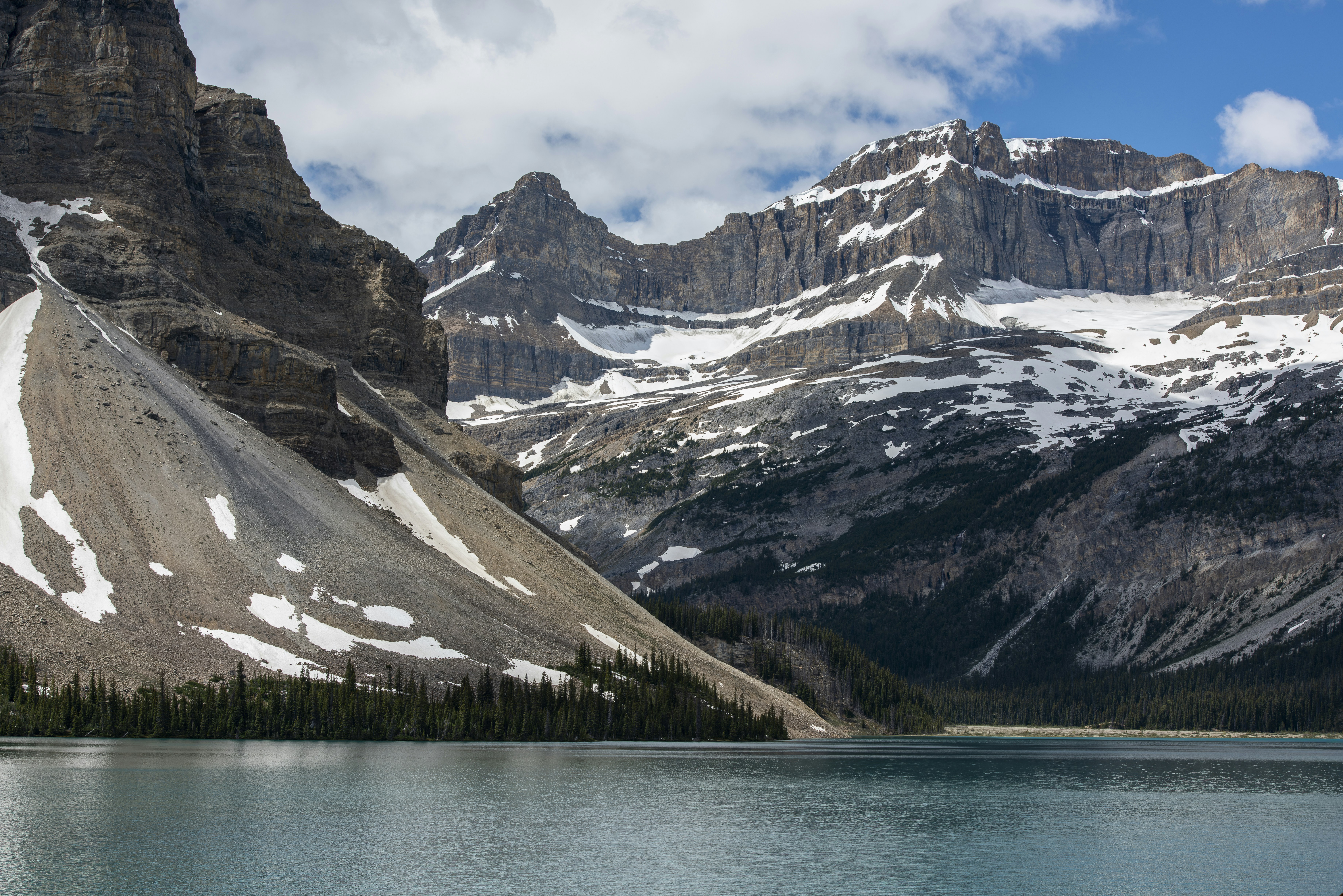 Majestic snow-capped mountains rise above a serene blue lake