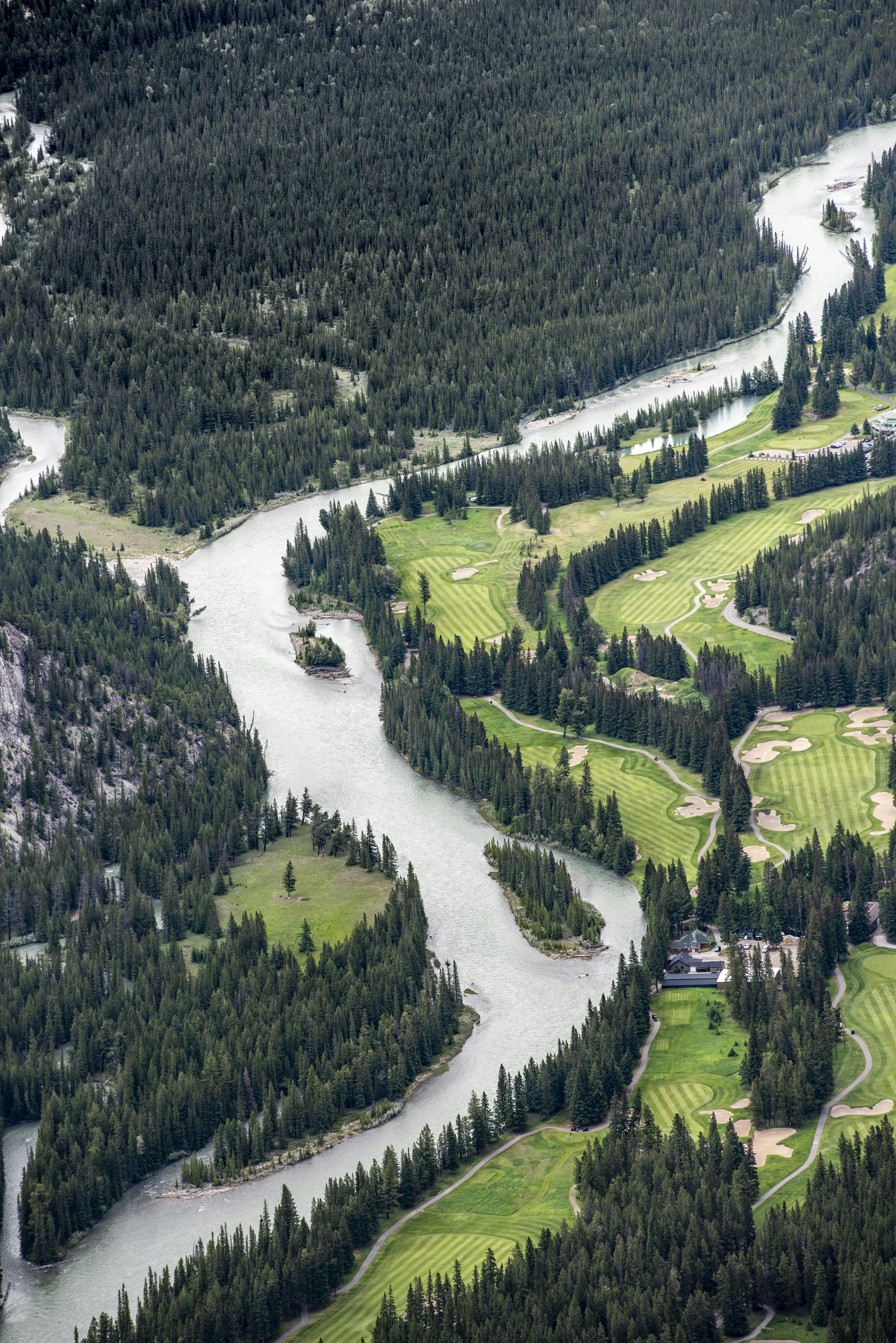 River meanders through dense forest and manicured golf courses
