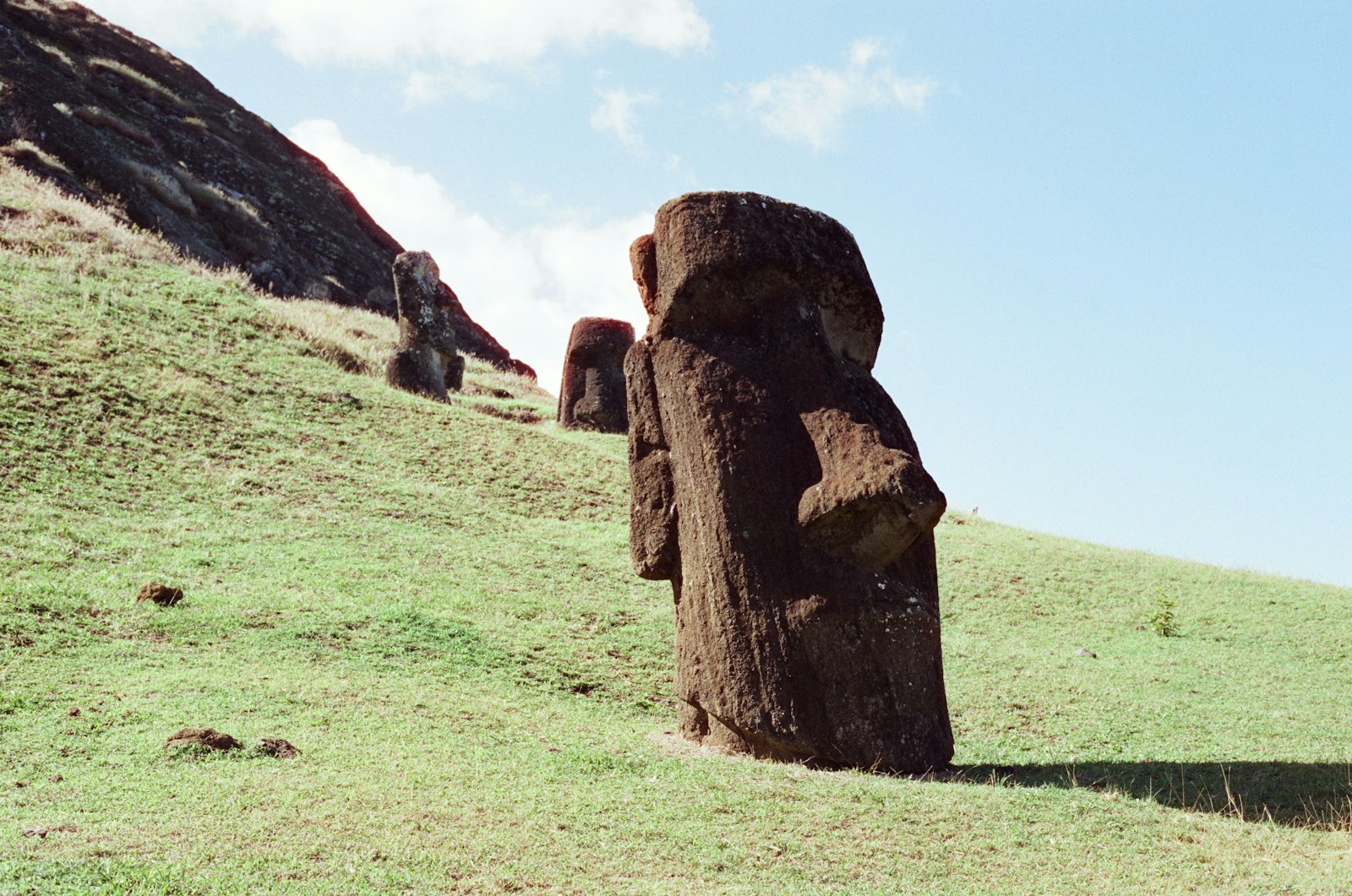 Moai statues standing on the green slopes of the Rano Raraku quarry on Easter Island