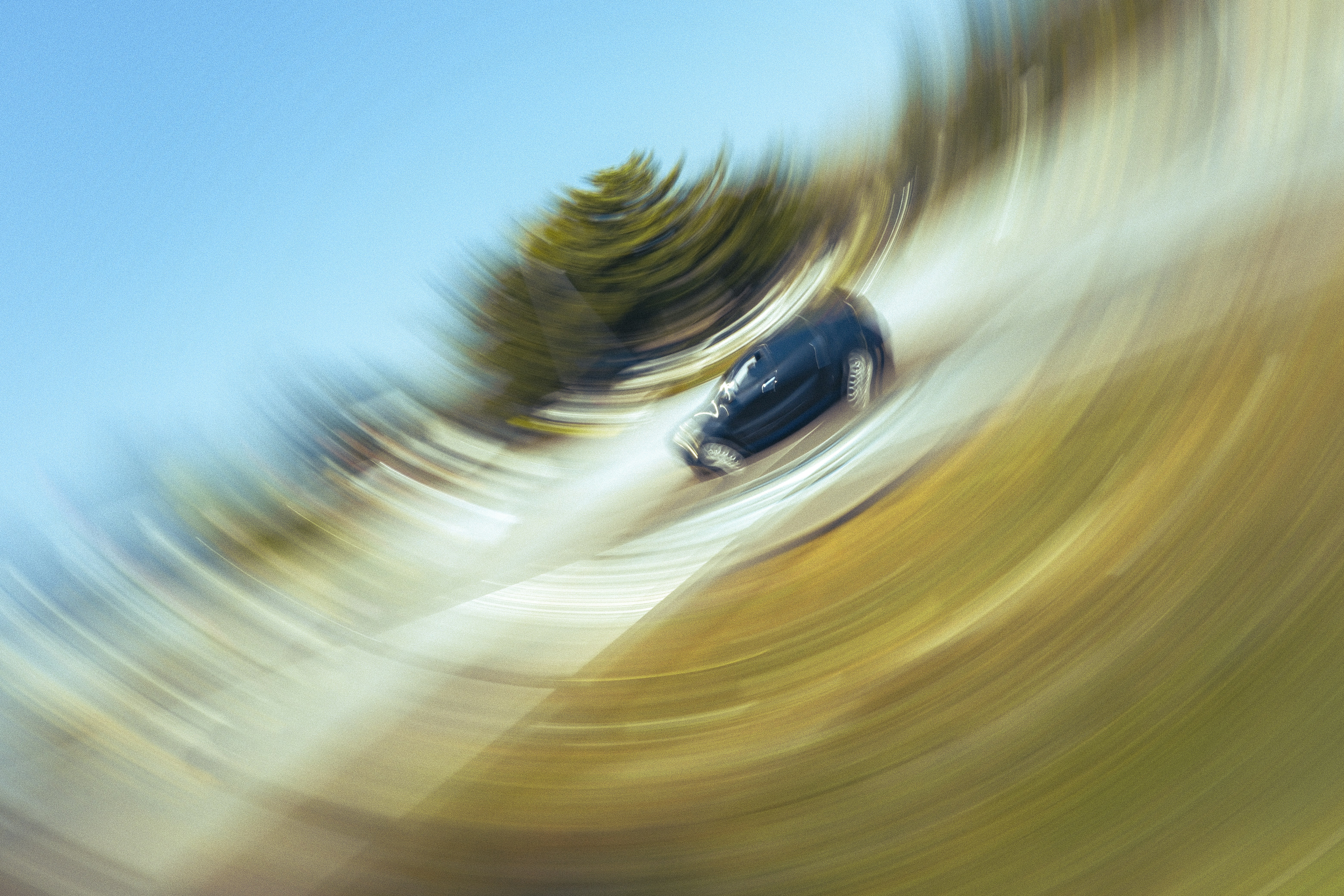Car speeding with intense motion blur and swirling background