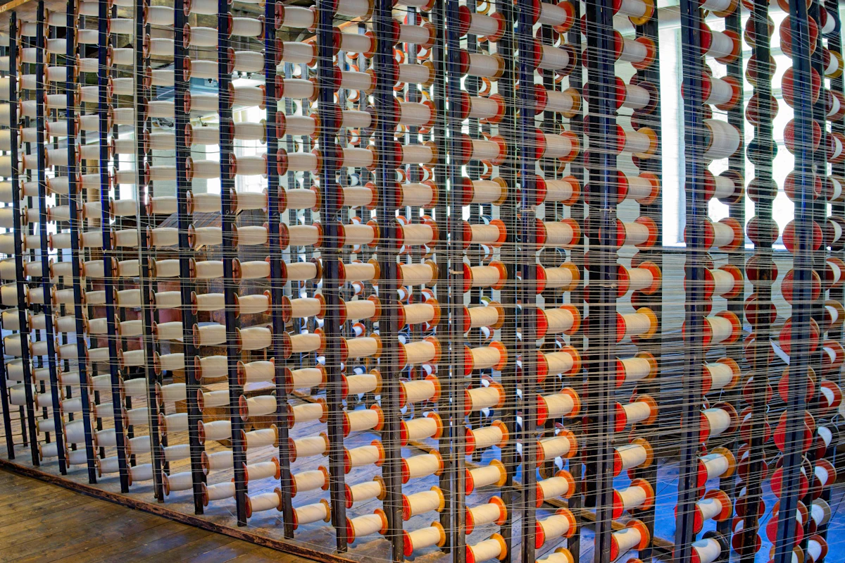 Rows of thread spools on a textile machine