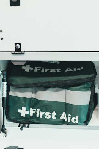 A stocked first aid kit stored in a hallway closet, ready for quick access
