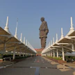 Massive statue overlooks a long pathway with white structures