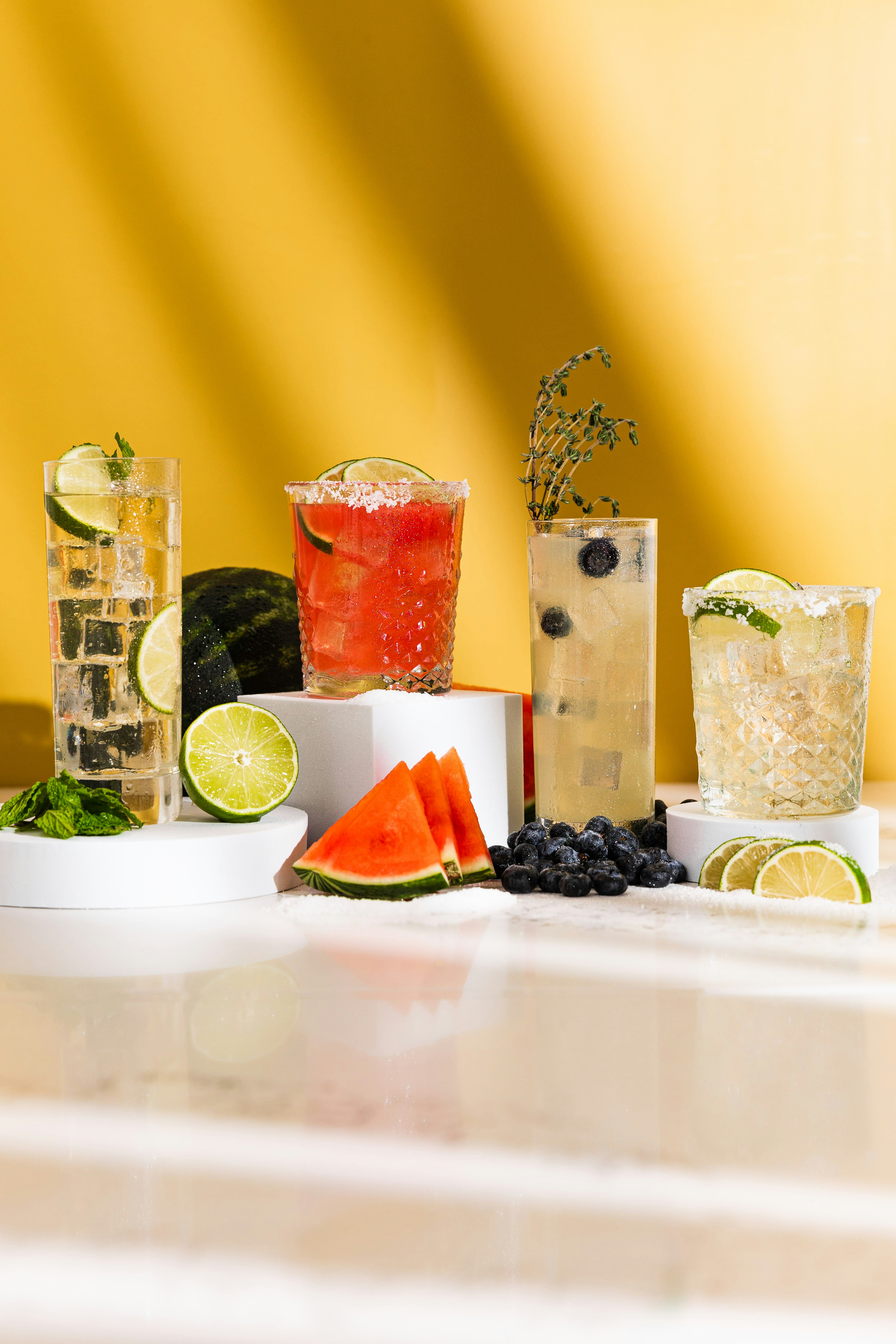 Variety of refreshing cocktails with fruit garnishes