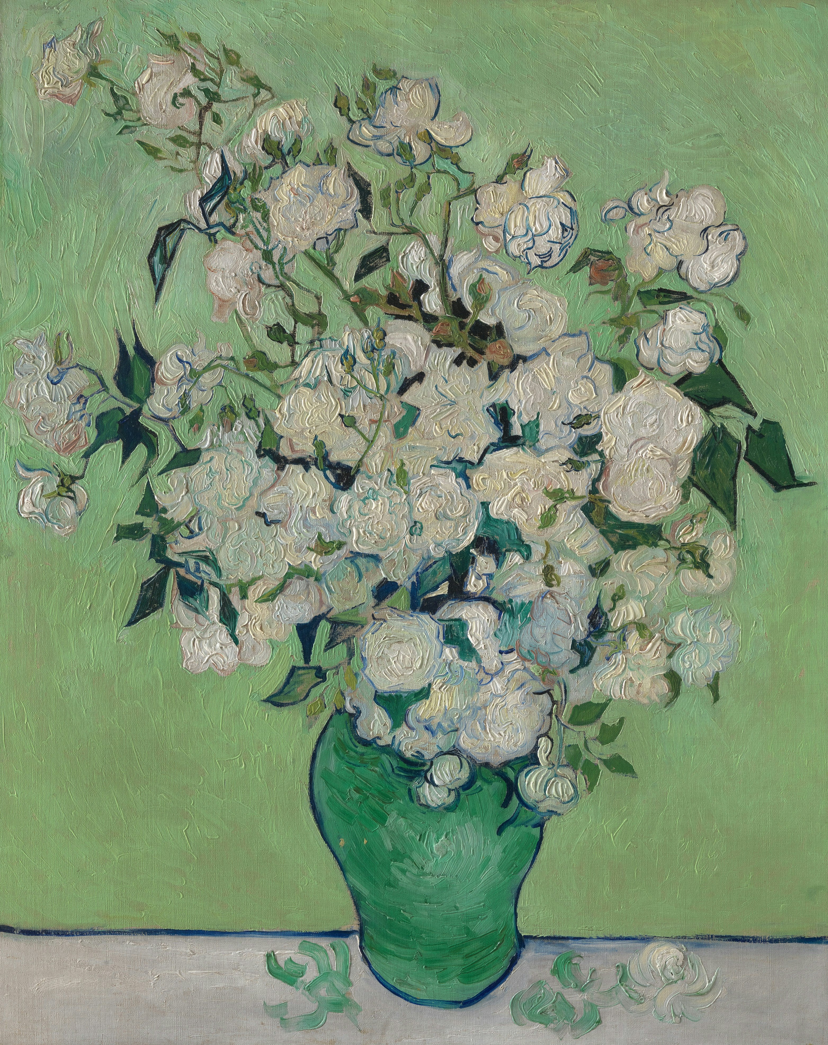 White roses in a green vase against a green background.