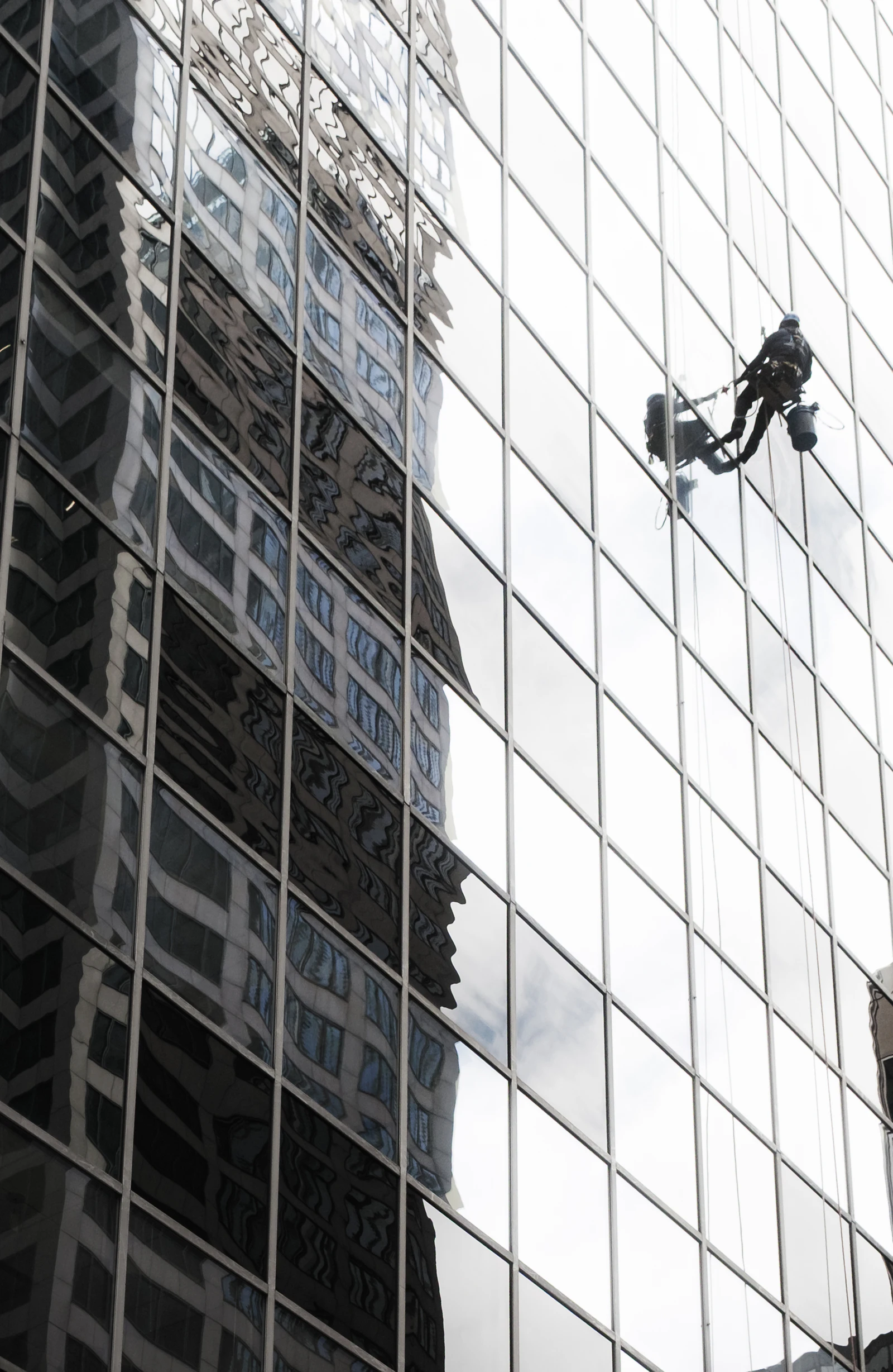 Window cleaner working on a glazed building facade