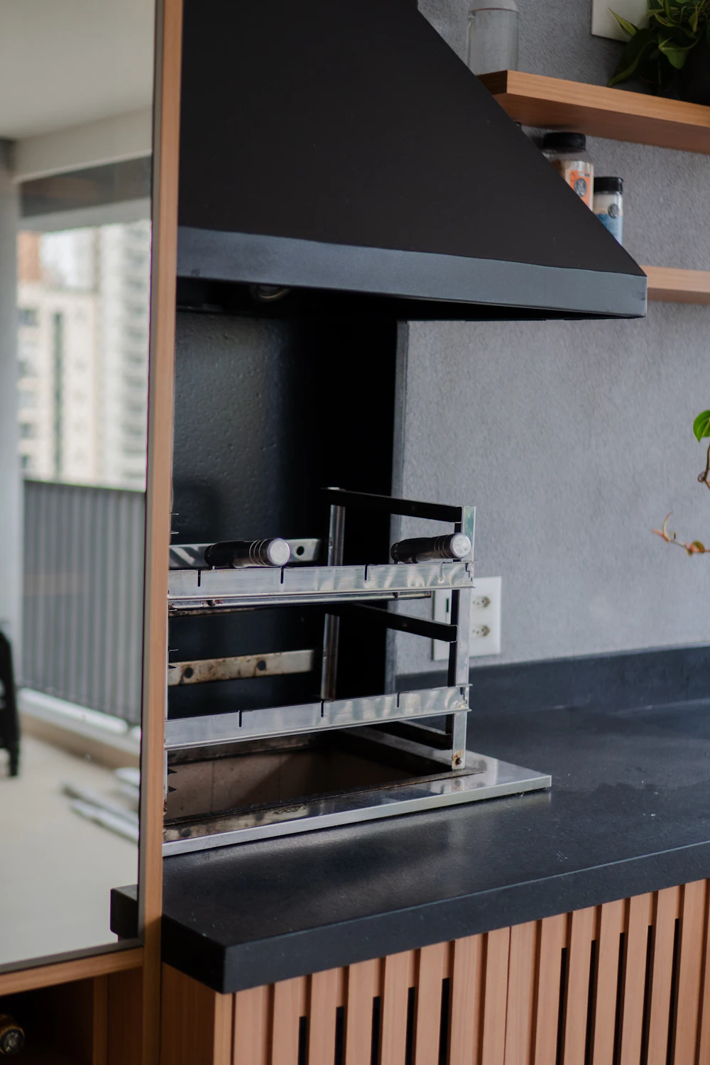 Barbecue grill set into a wooden cabinet base