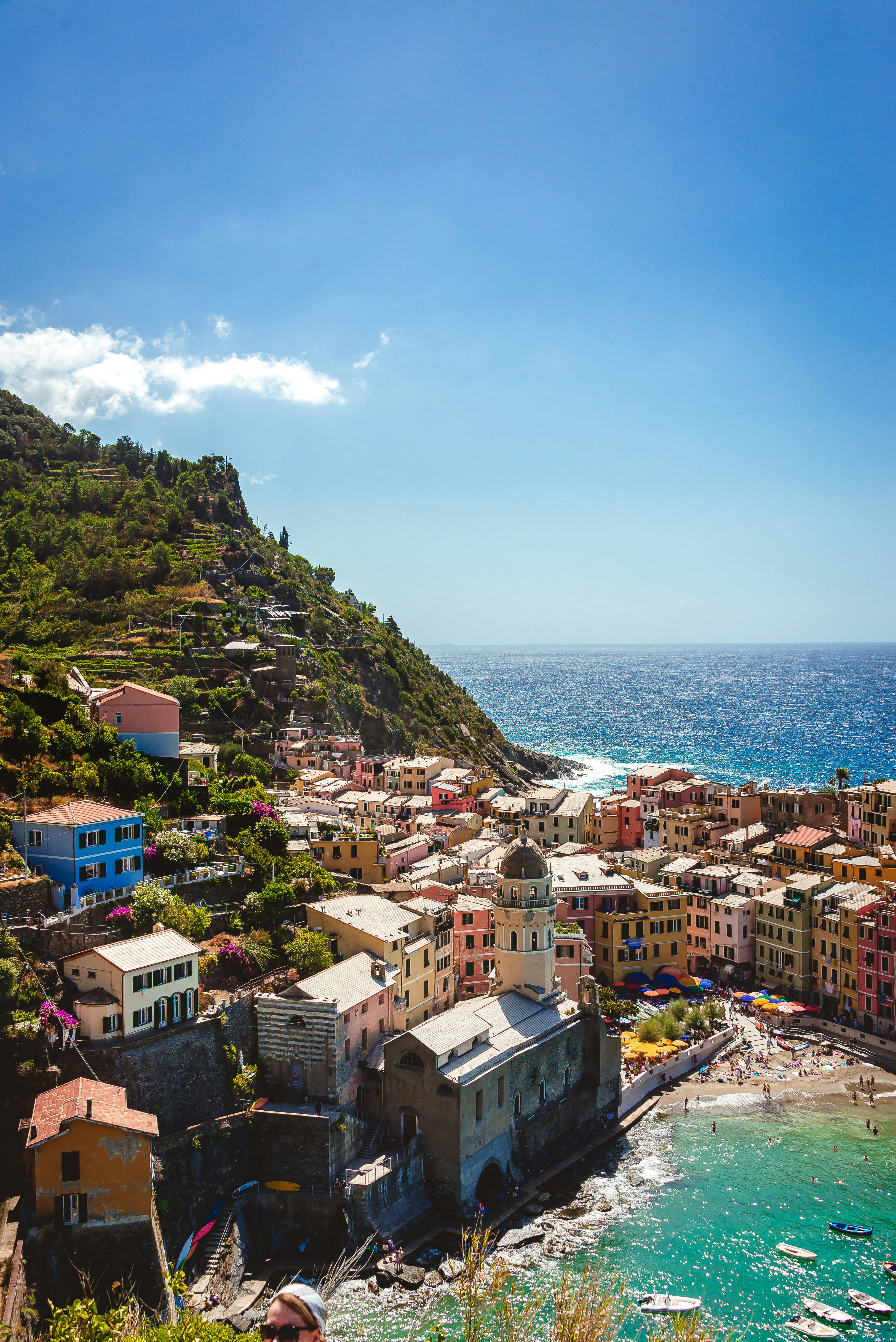 Colorful village on a hillside overlooking the clear blue sea
