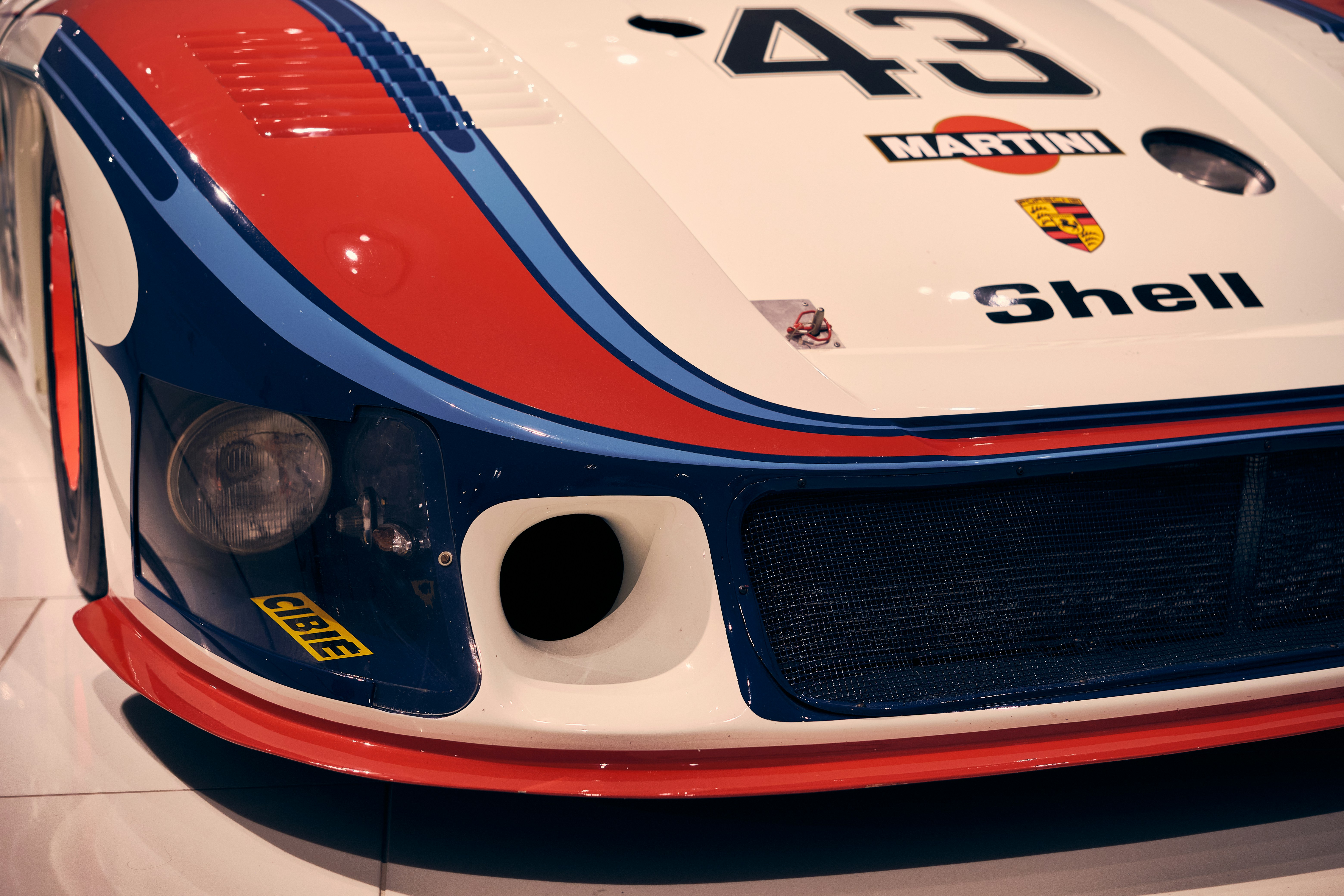 Cars Front Of A White, Red, And Blue Porsche Race Car. 4K Wallpaper #2384