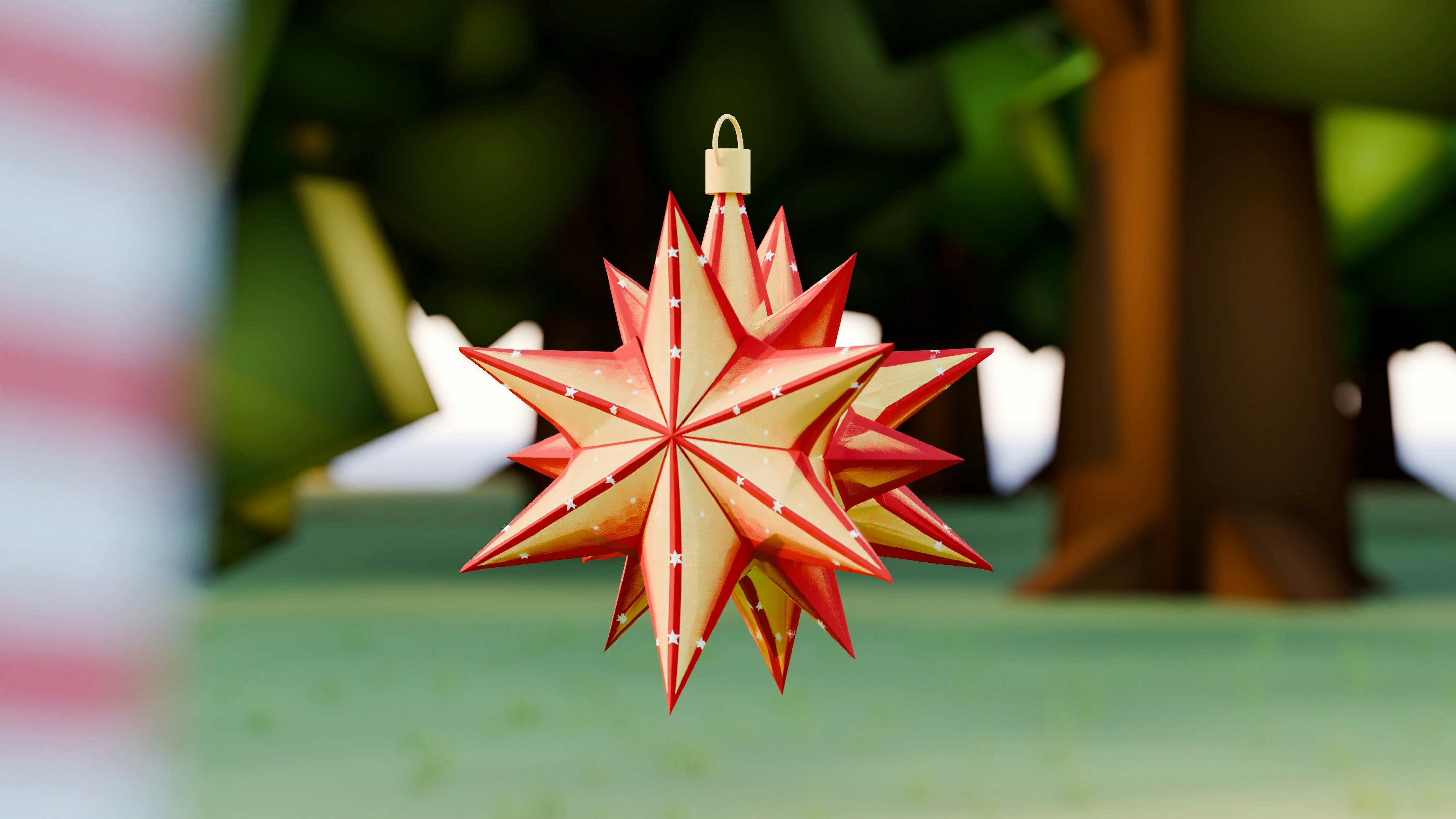A festive star ornament hangs from a tree branch.