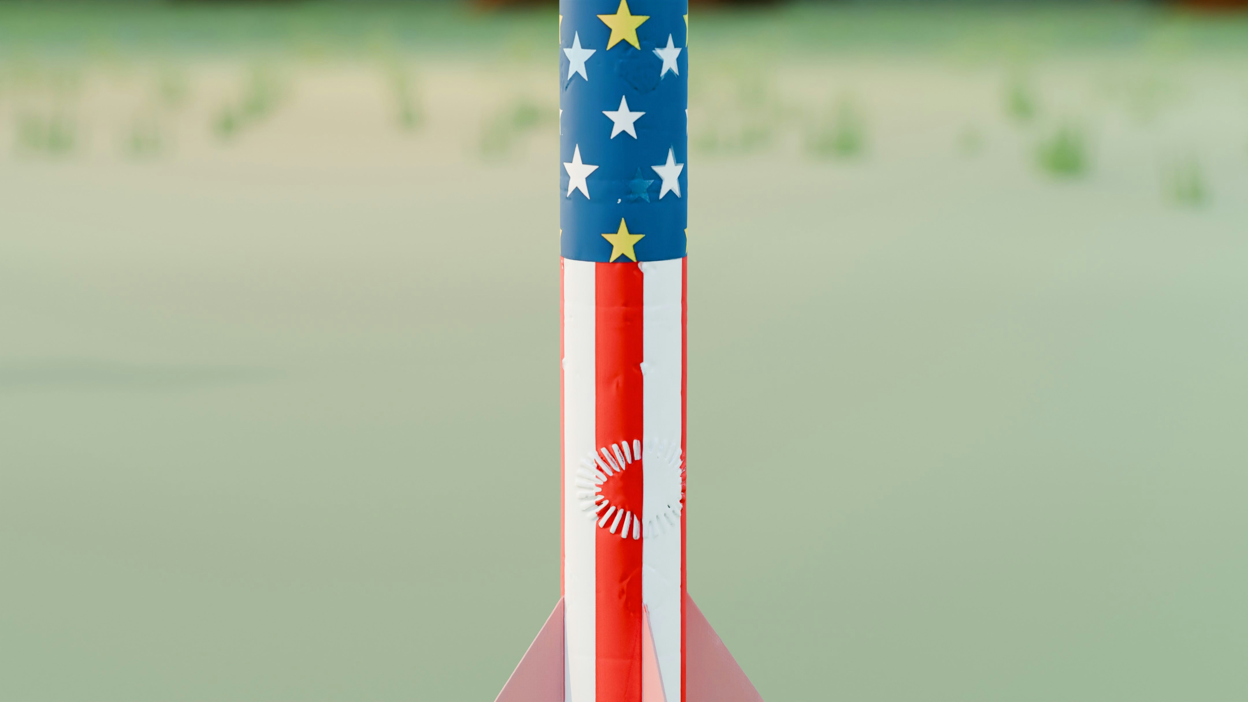 A model rocket painted with an american flag design.