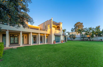 Spacious house with a vibrant green lawn.