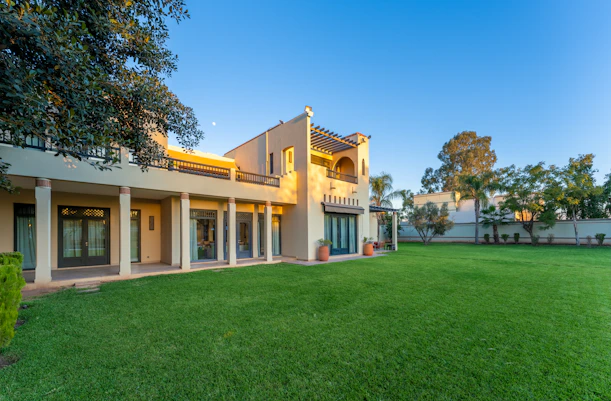 Spacious house with a vibrant green lawn.