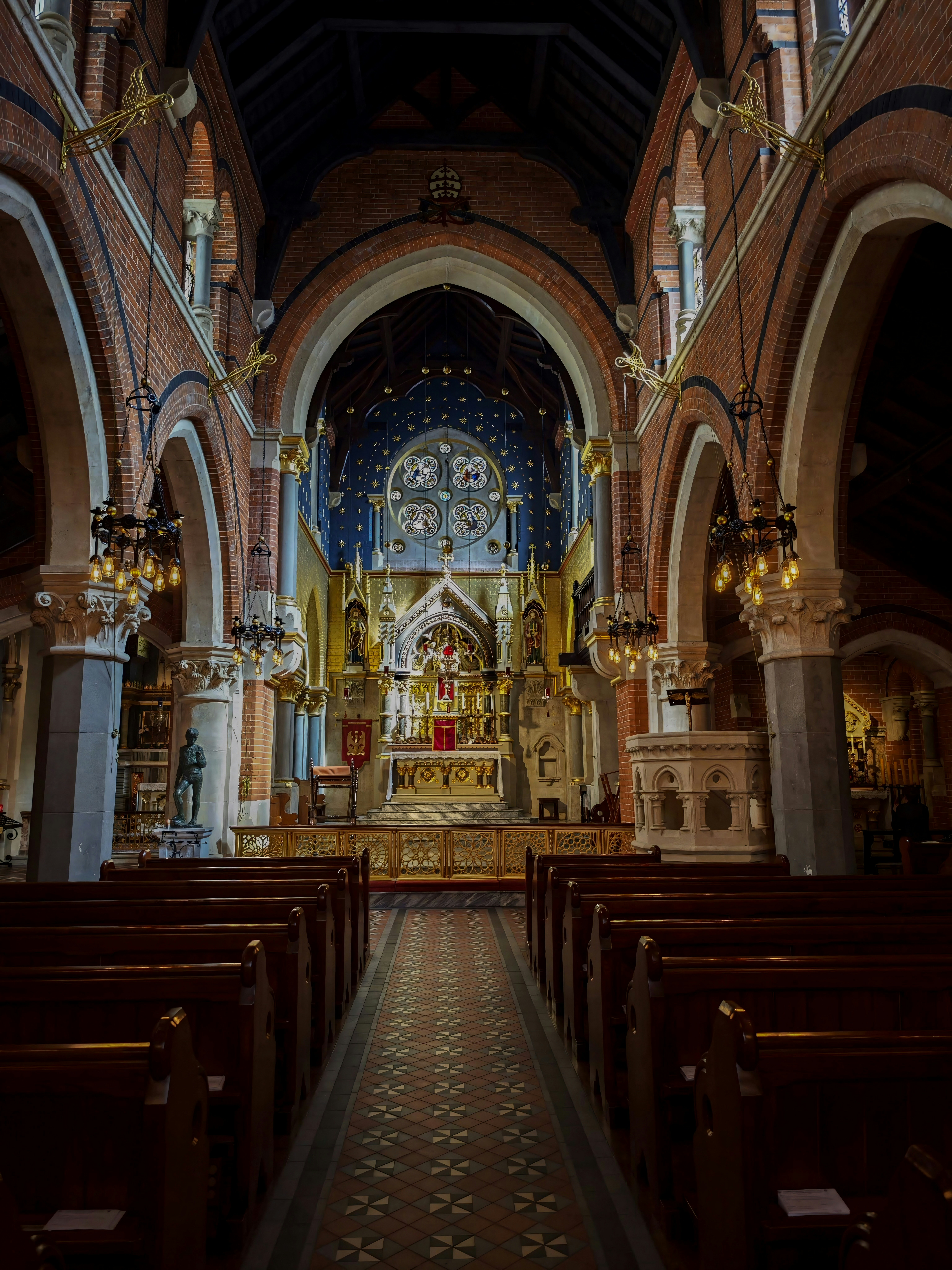 The peaceful interior of a Catholic church with pews leading toward a decorated altar