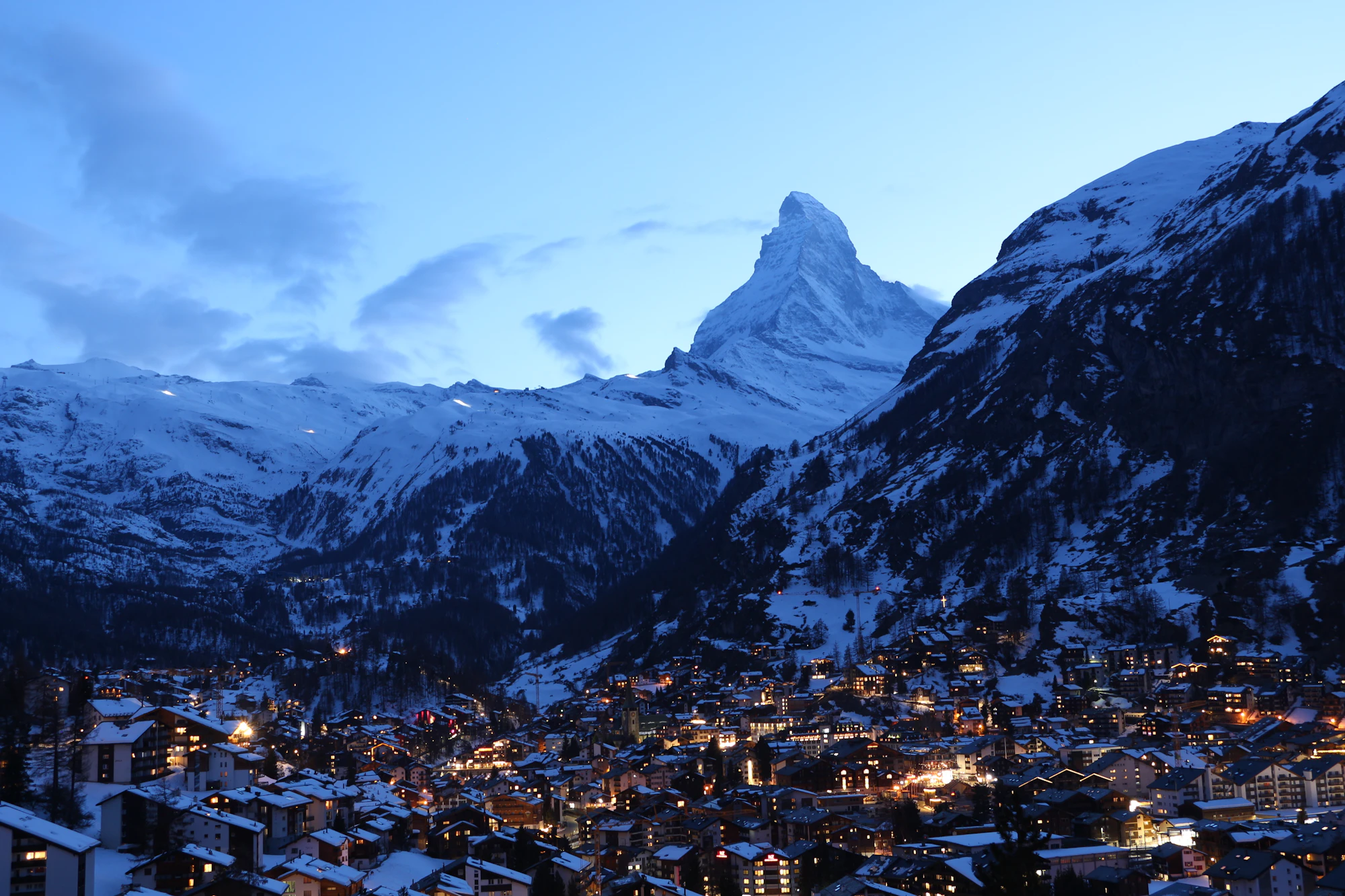 The village lit at dusk beneath the peak