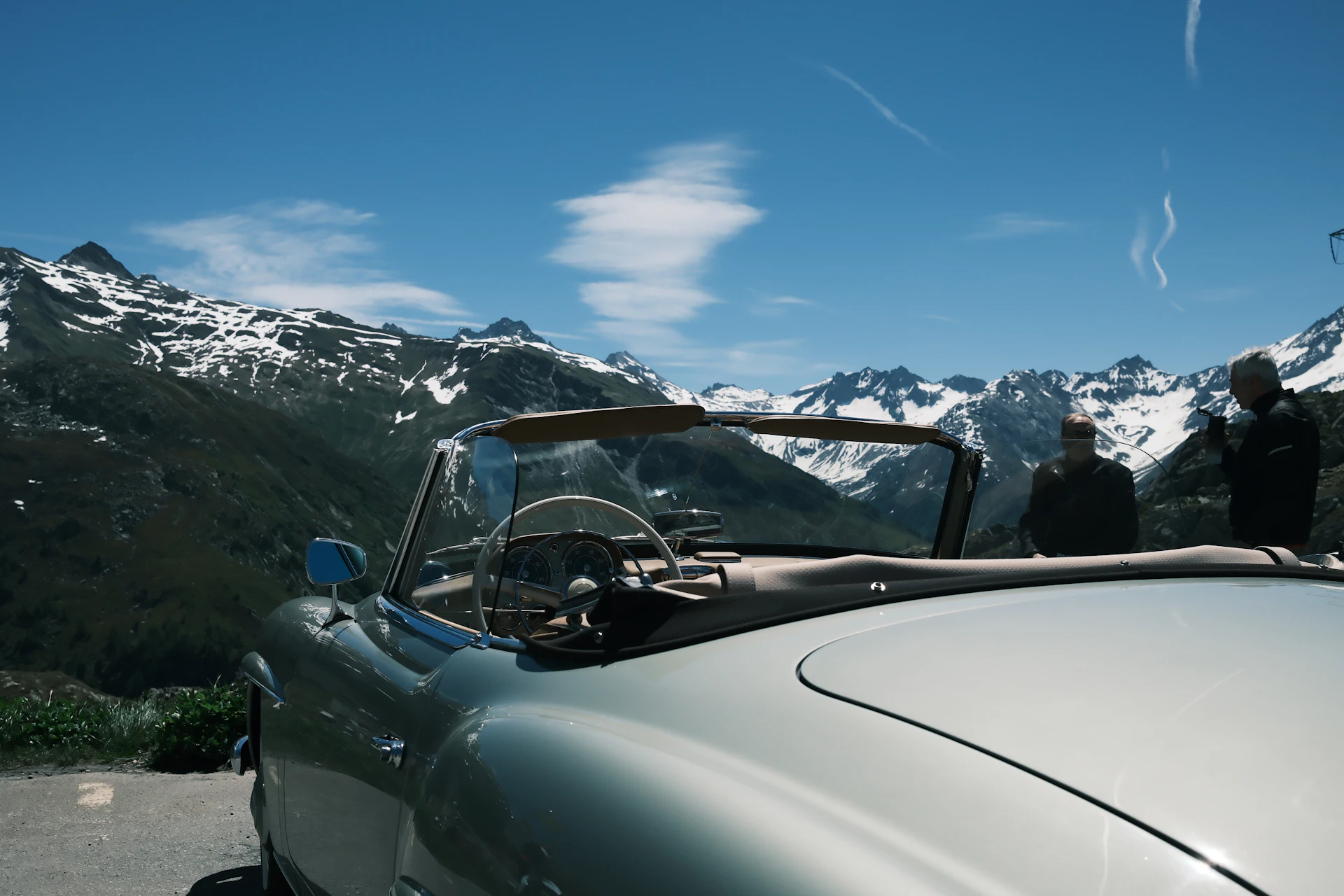 A classic car on a winding mountain road