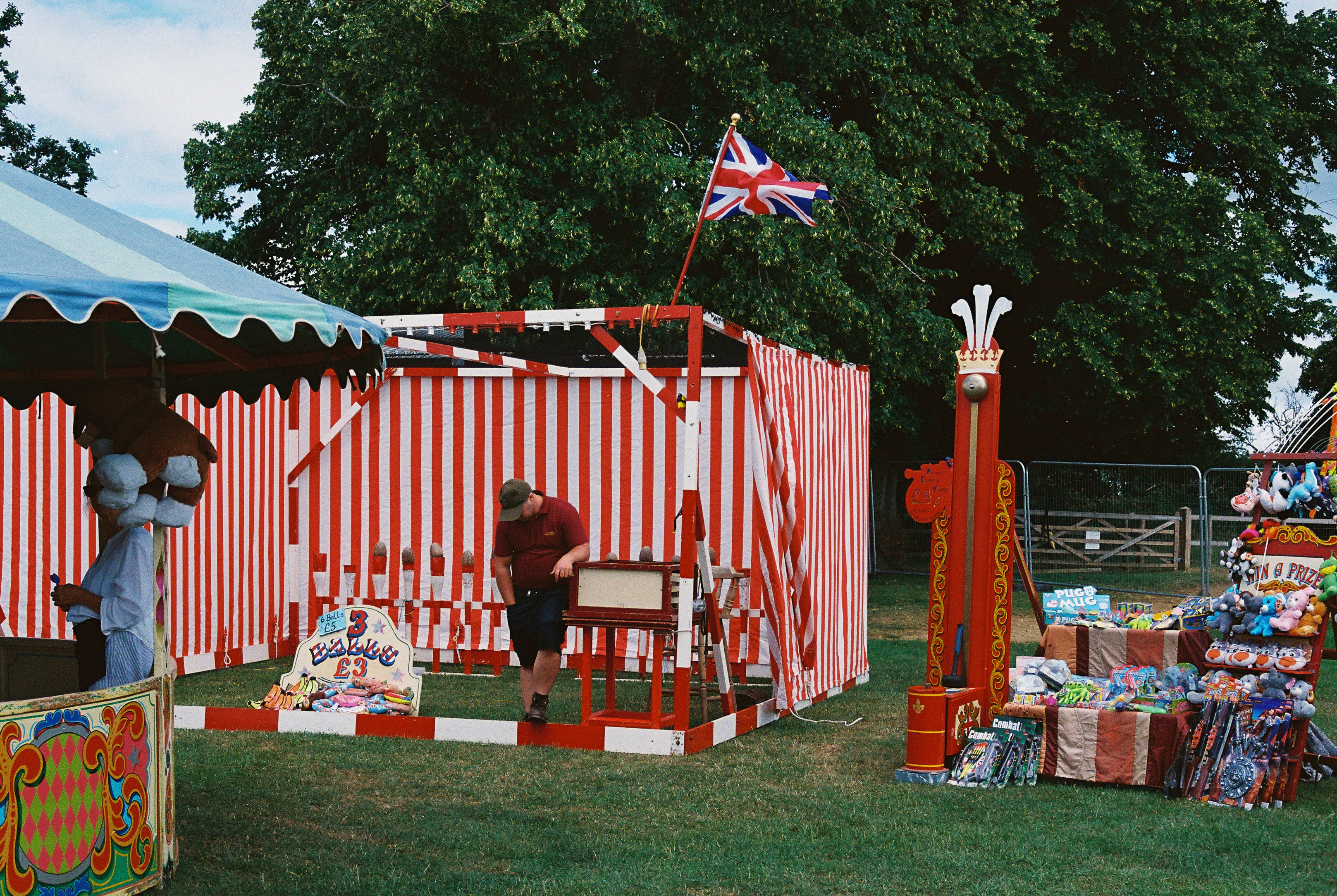 British fairground with games and red striped stalls
