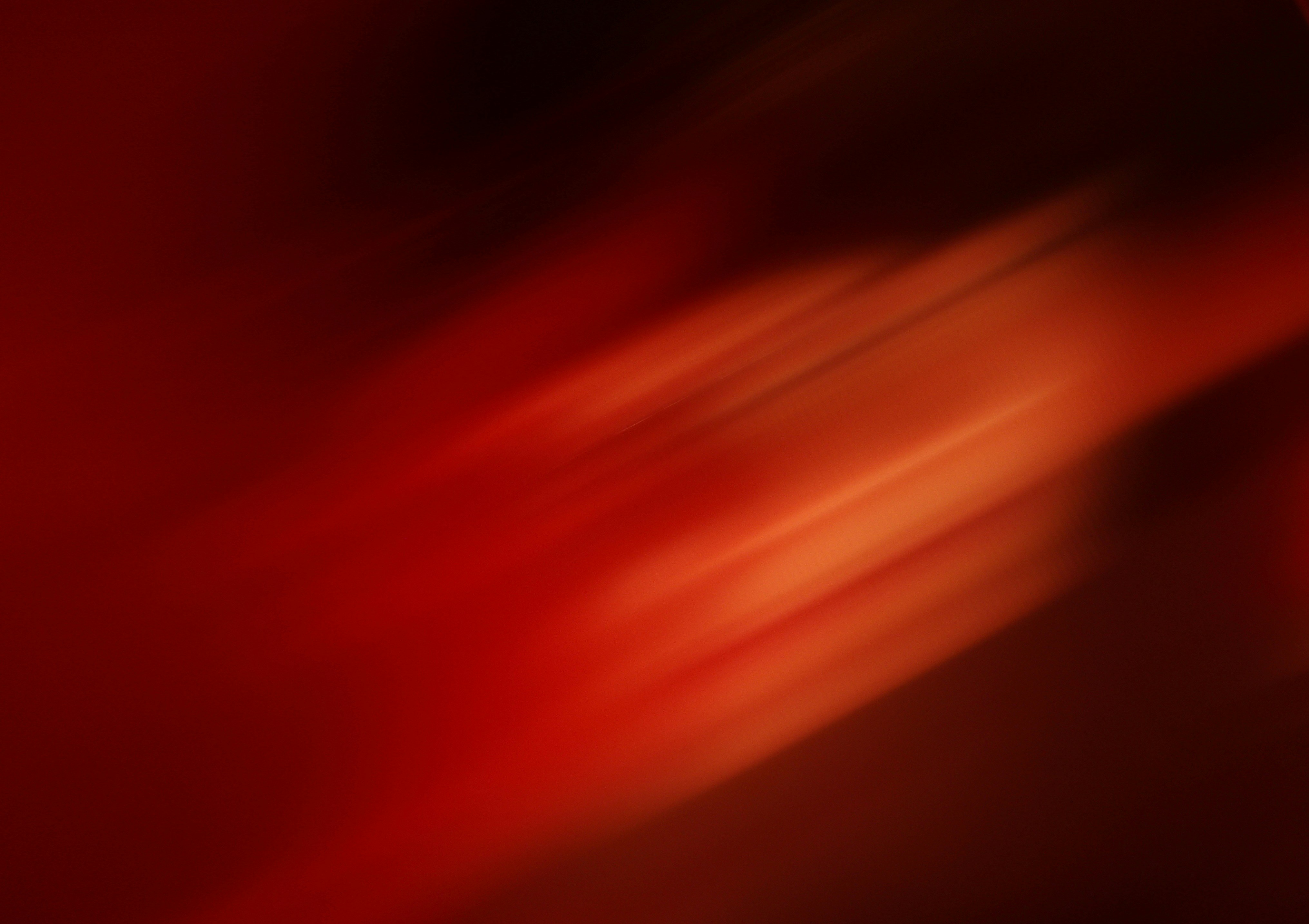 Red and orange light streaks on a dark background