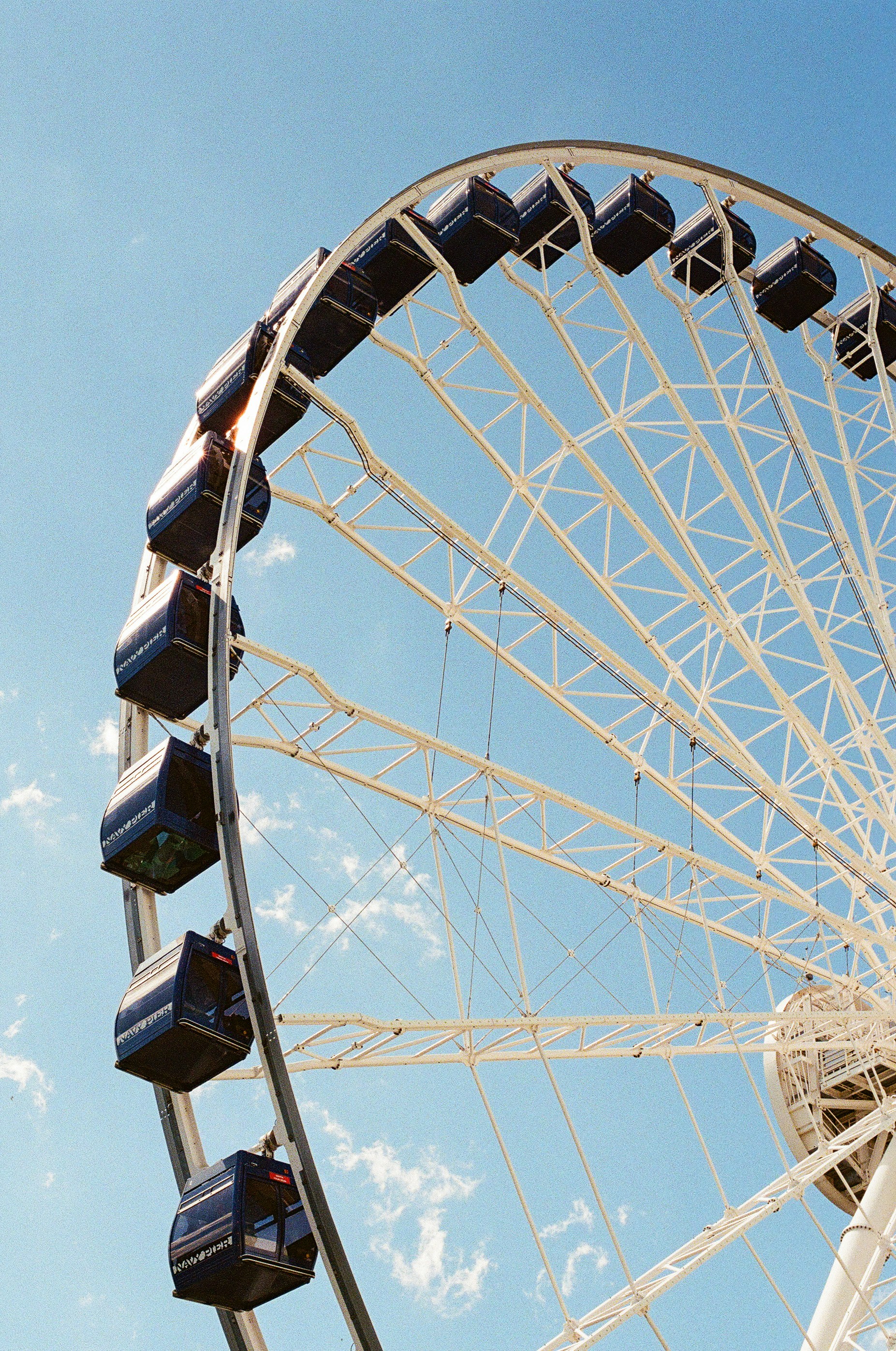A large ferris wheel against a clear blue sky.