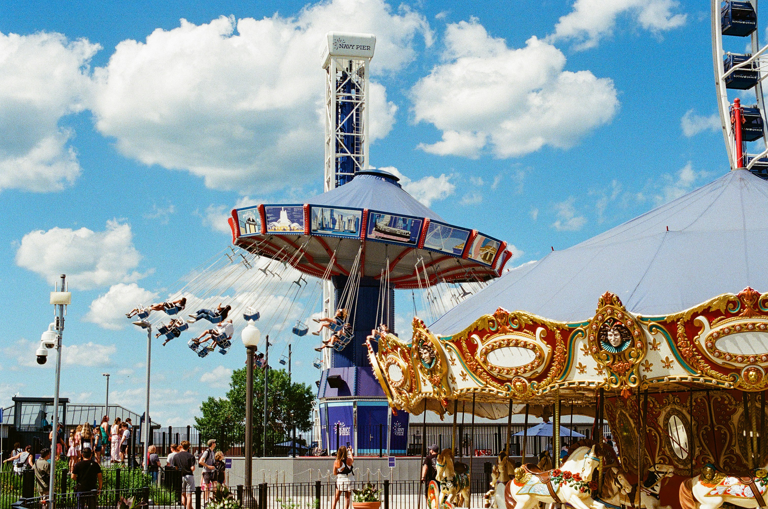 Carousel, swing ride, and drop tower at an amusement park. photo – Free ...