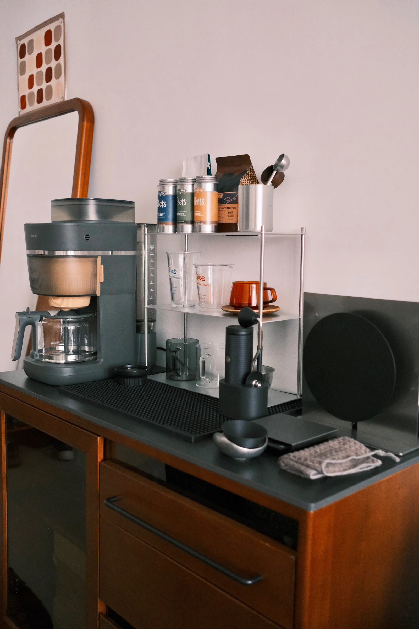 A home coffee station on a kitchen counter with a coffee maker and grinder