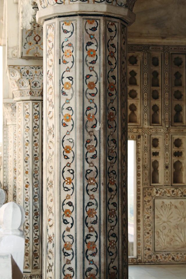 Intricately carved marble column with colorful floral inlay designs