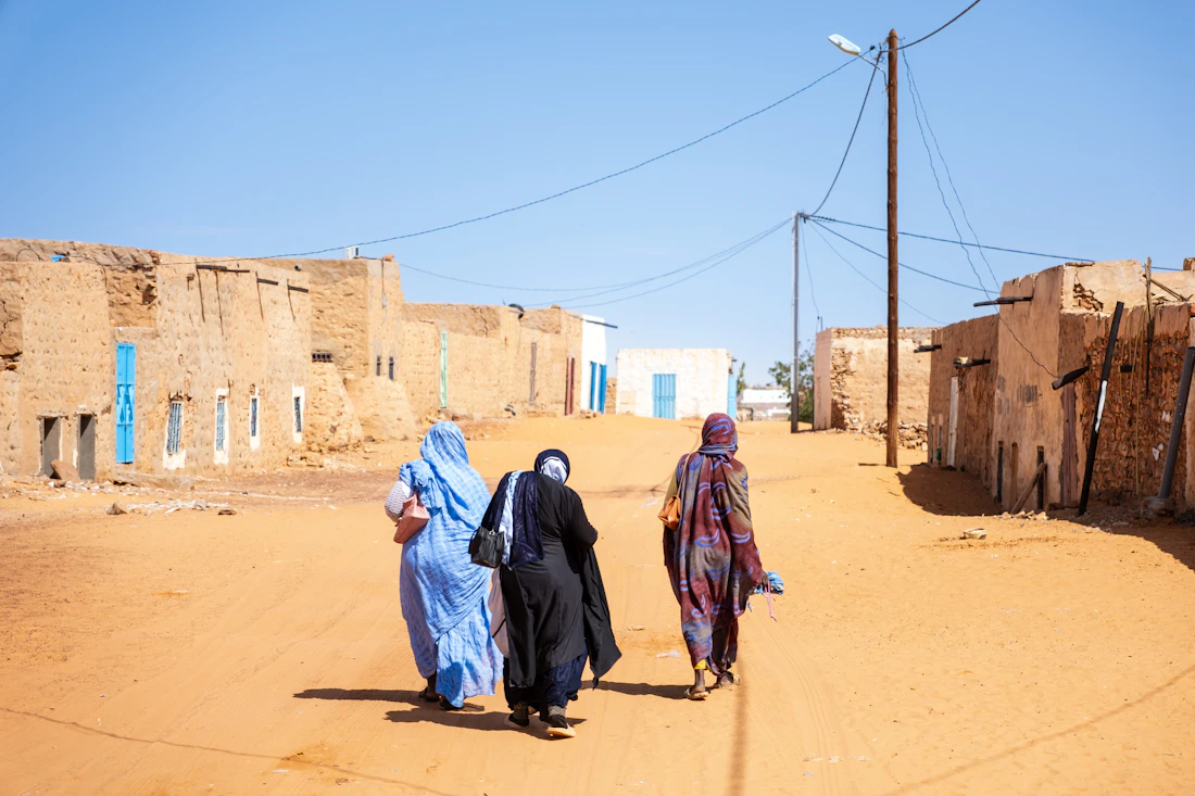 Women walking along a sunlit street