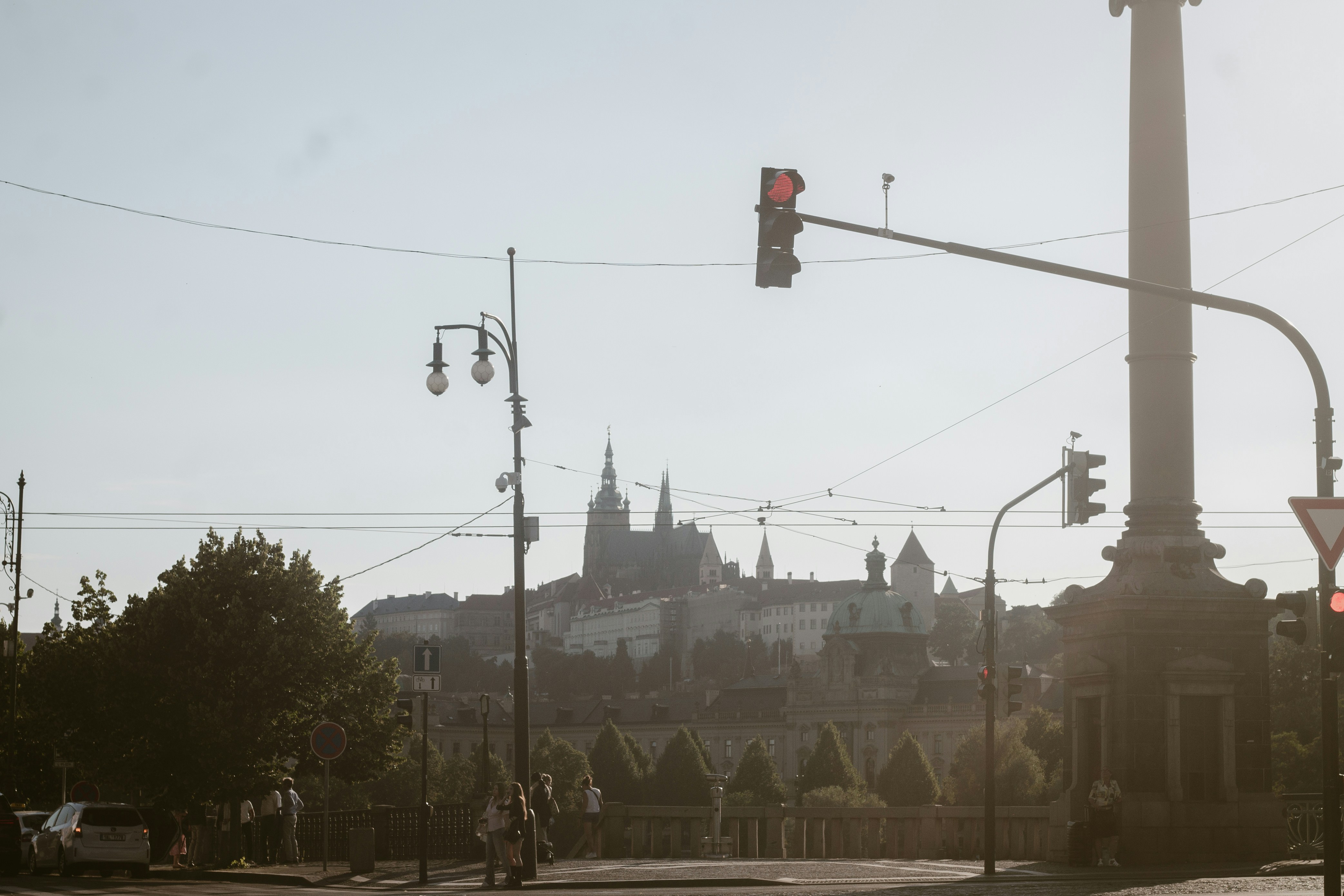Prague castle in the distance with street lights and traffic.