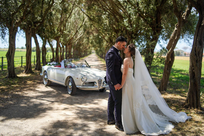 elegant bride and groom beside a vintage car