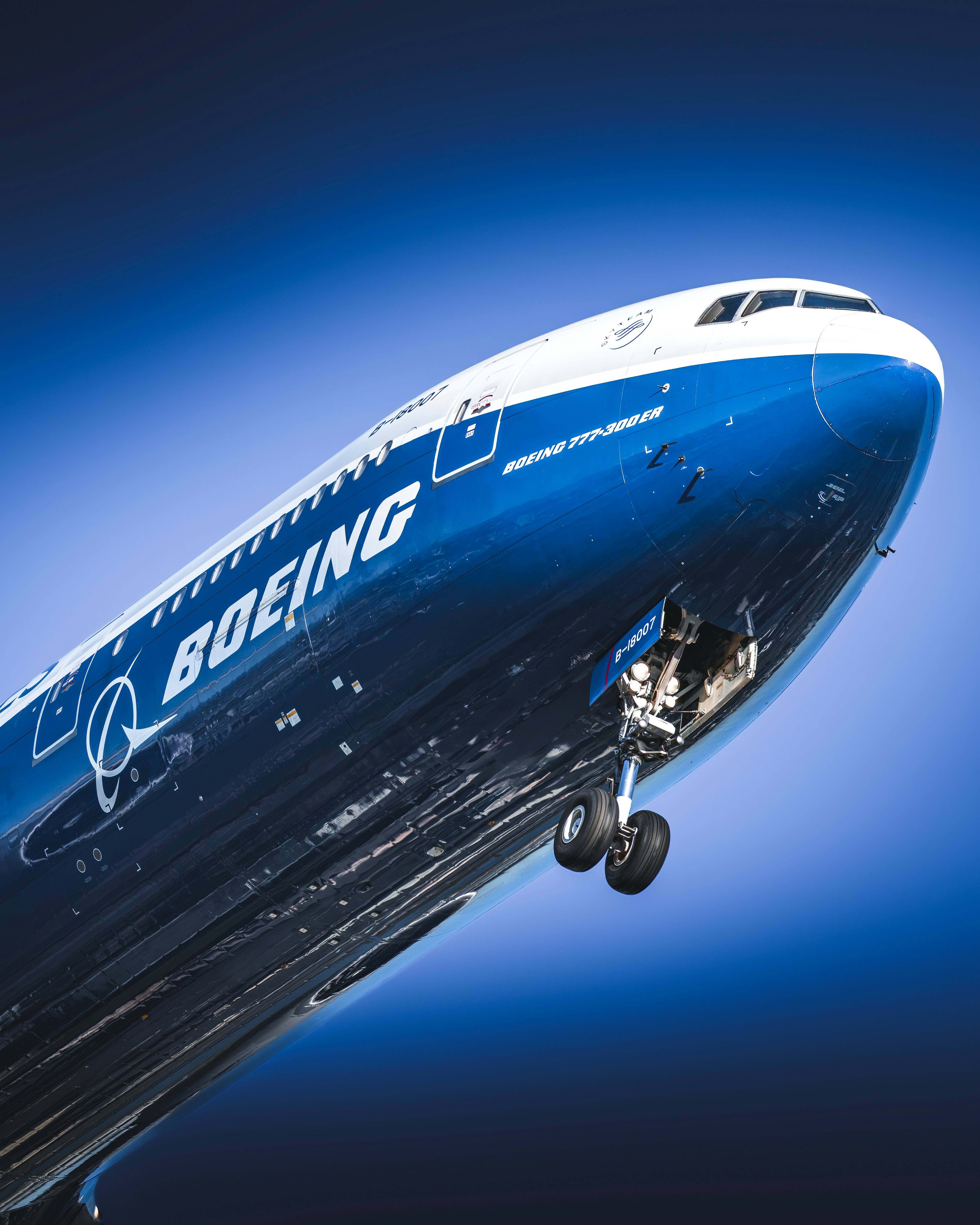 Underside of a boeing airplane with landing gear extended.