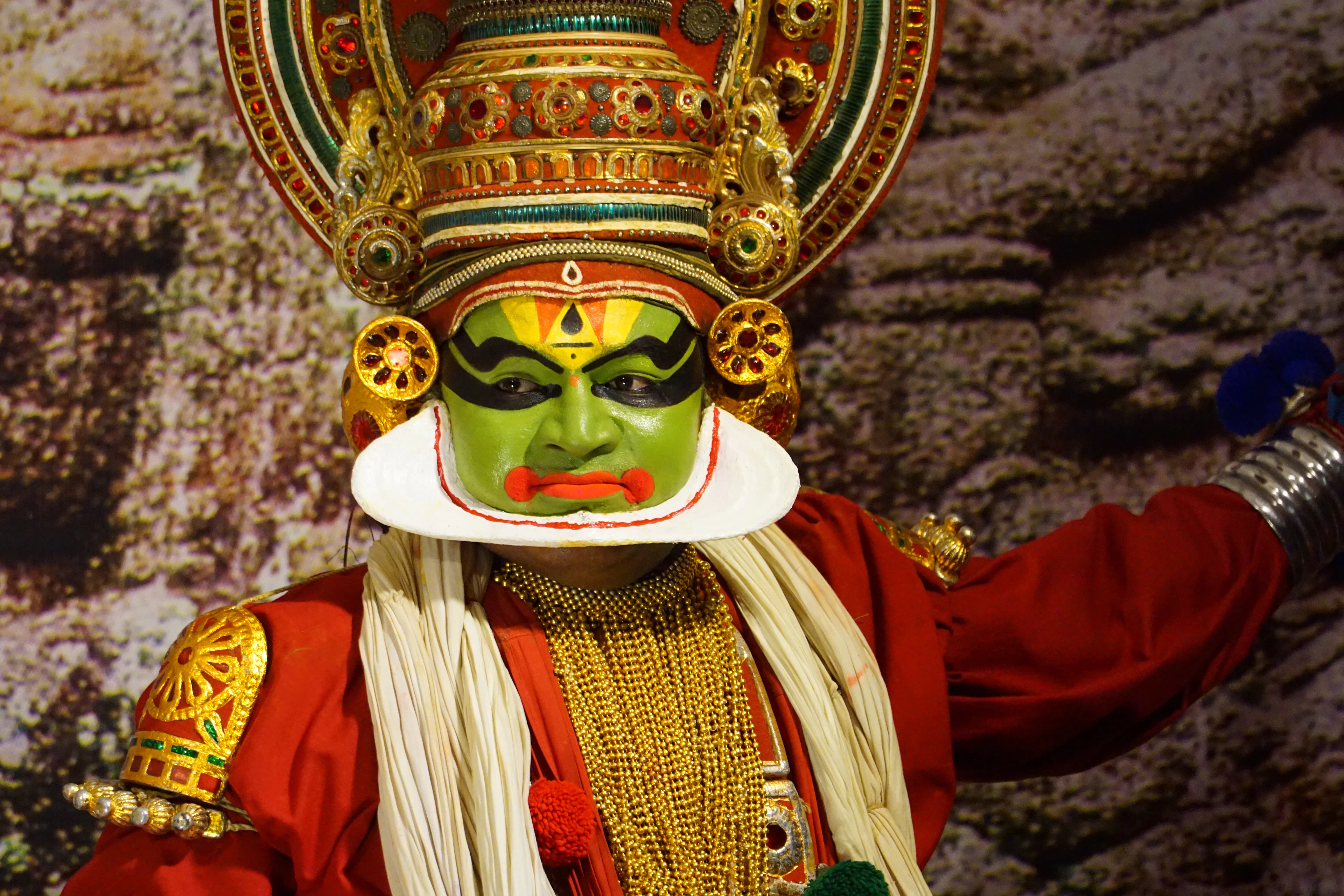 Kathakali dancer in traditional costume and hand-painted green facial makeup