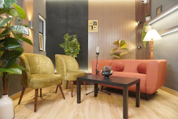 Stylish modern studio with sofa, armchairs, and plants