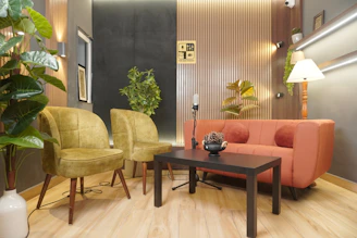 Stylish modern studio with sofa, armchairs, and plants