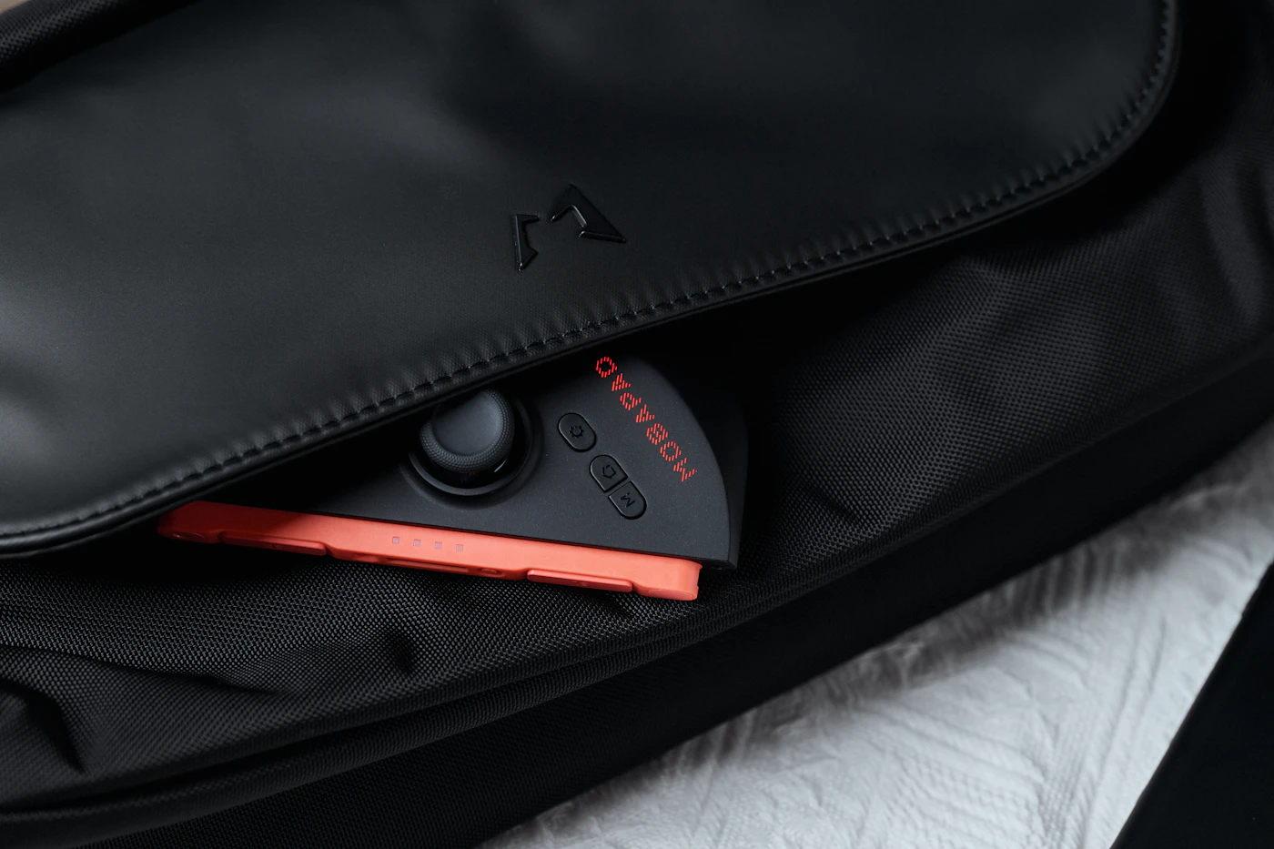 Passport and electronic device stored together inside a protective travel bag