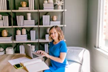 Smiling woman working on laptop at a desk