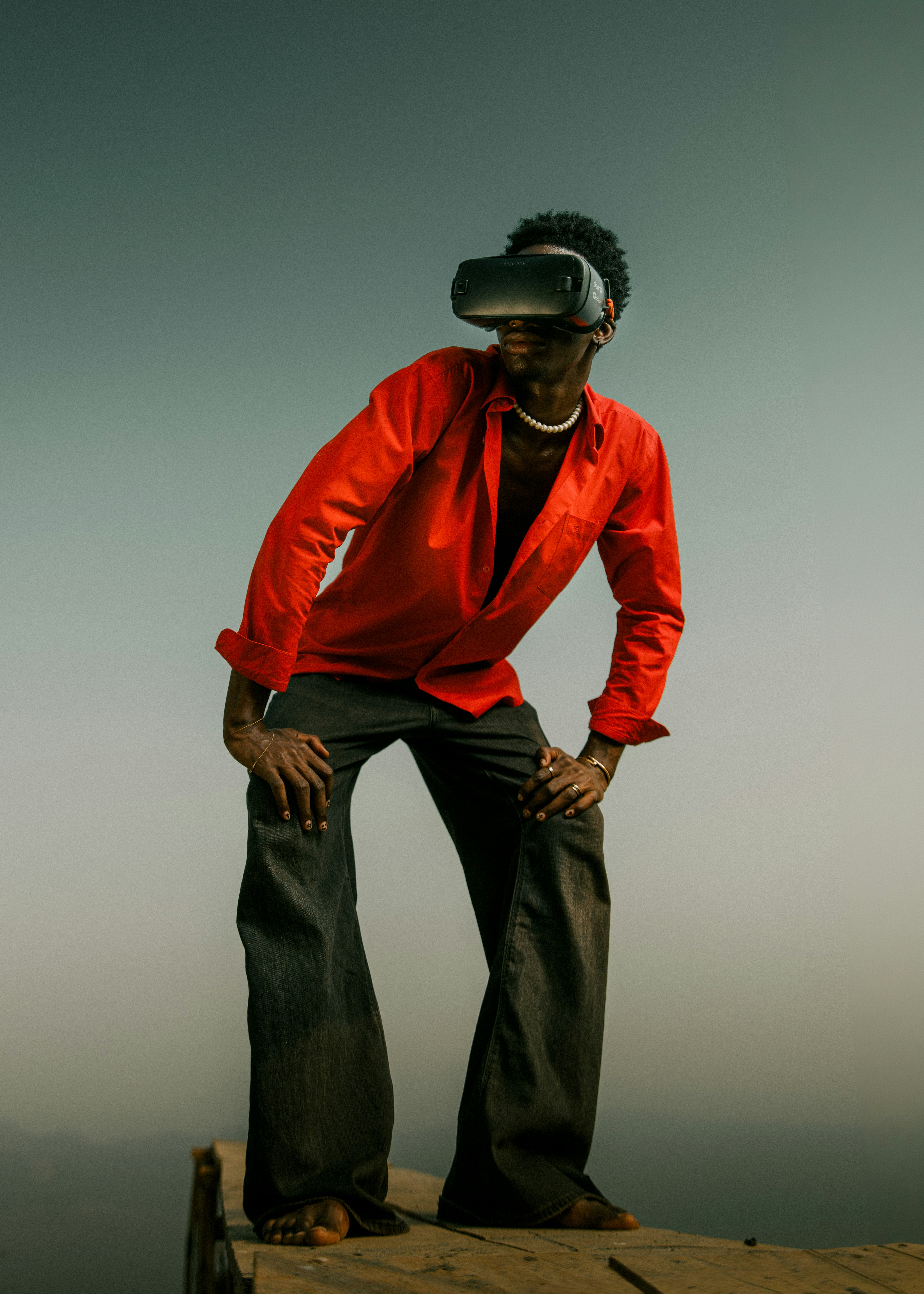 A man wearing a vr headset stands on a platform.