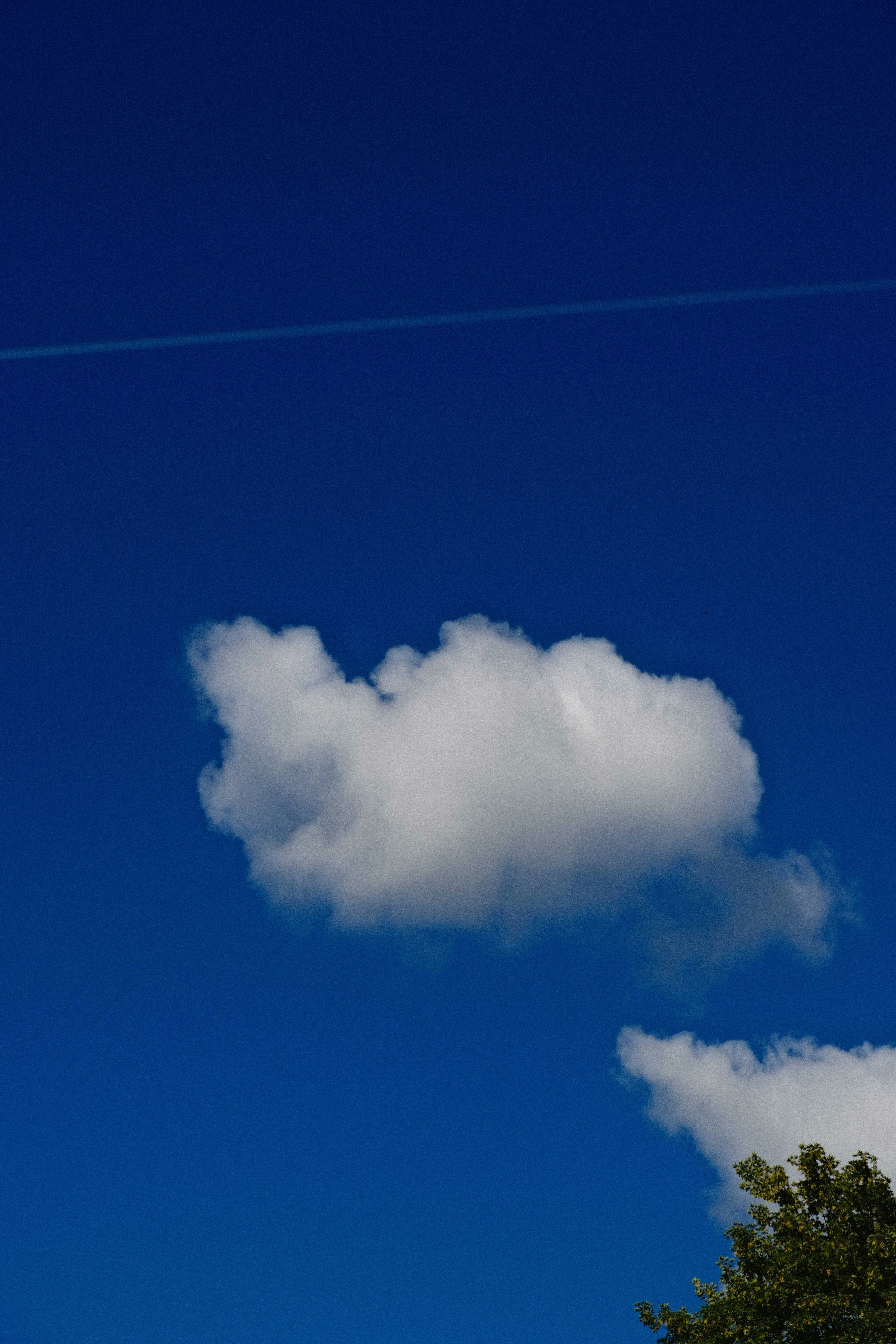 A white cloud in a vibrant blue sky