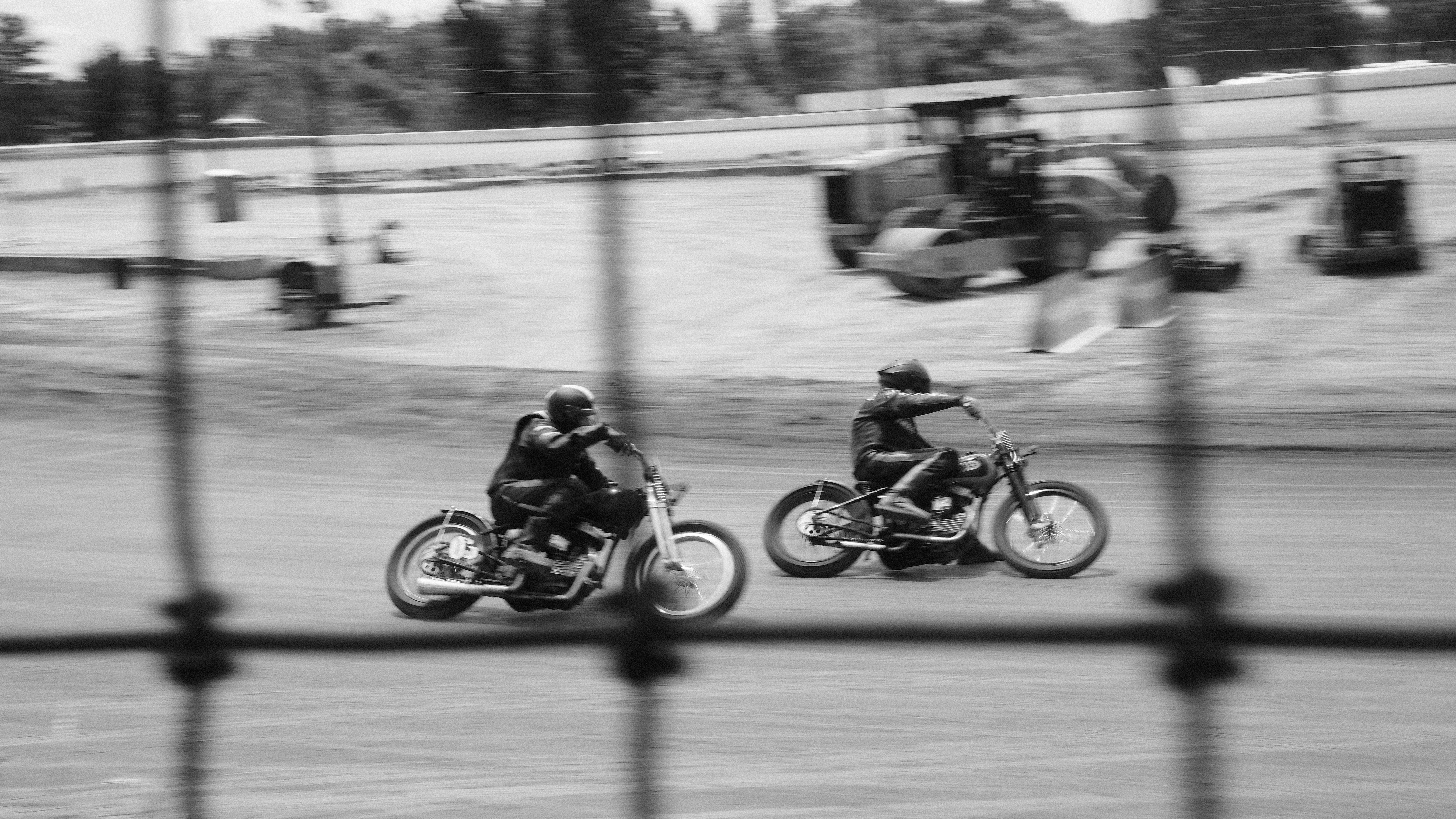Two motorcyclists race on a dirt track