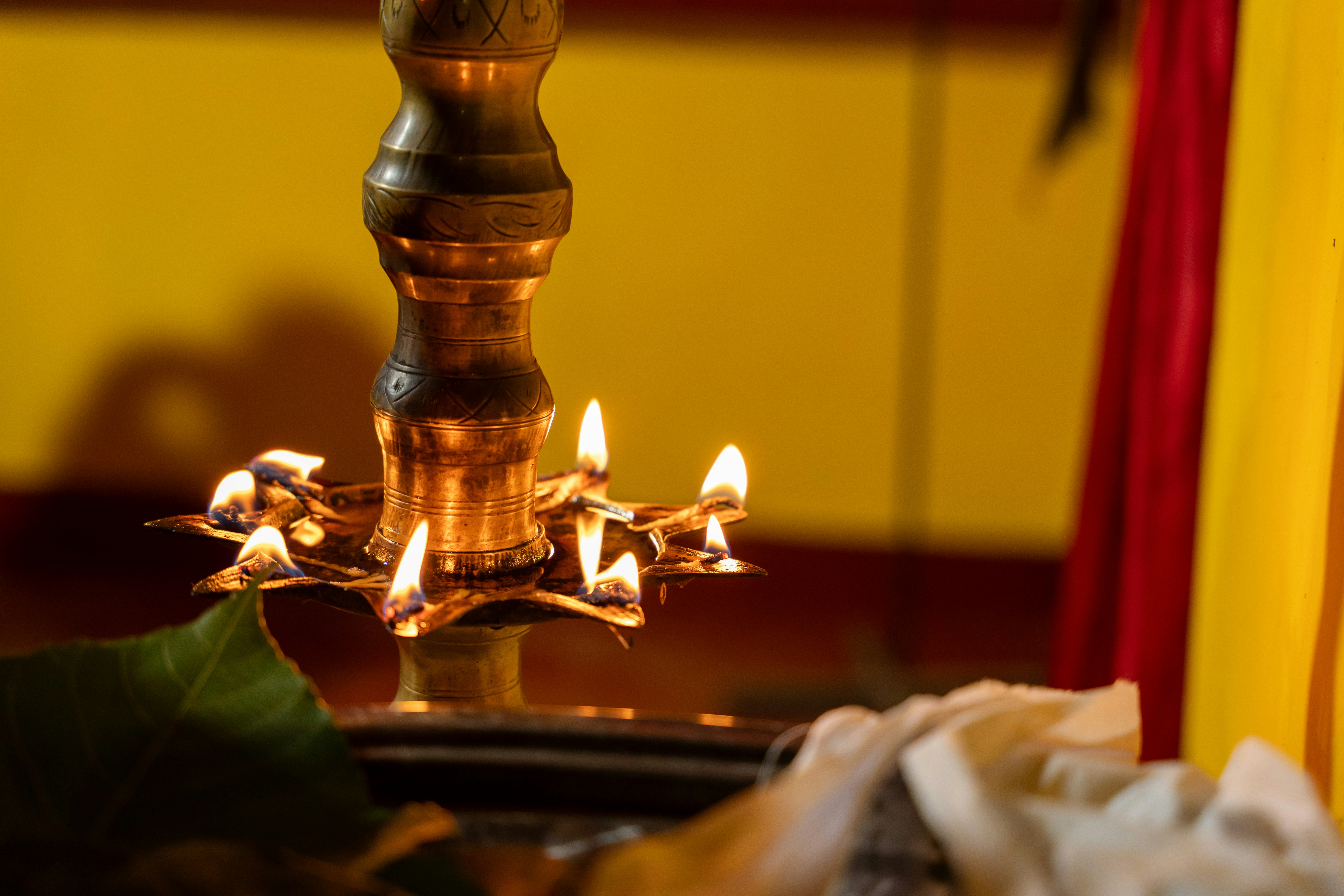 Traditional Kerala brass lamp and manuscript