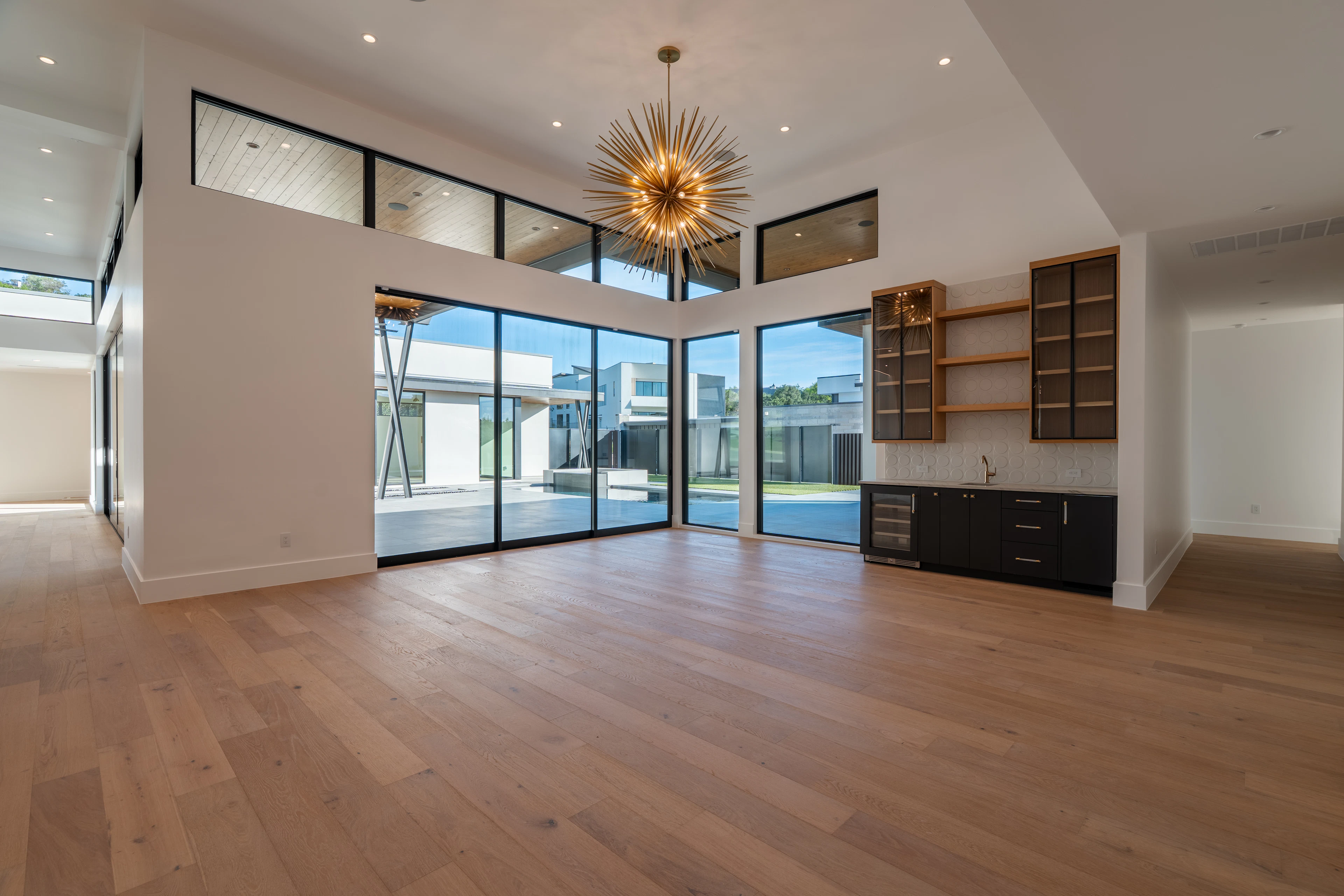 Spacious modern room with wood floors and large windows