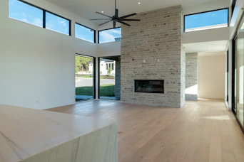 Modern living room with stone fireplace and large windows