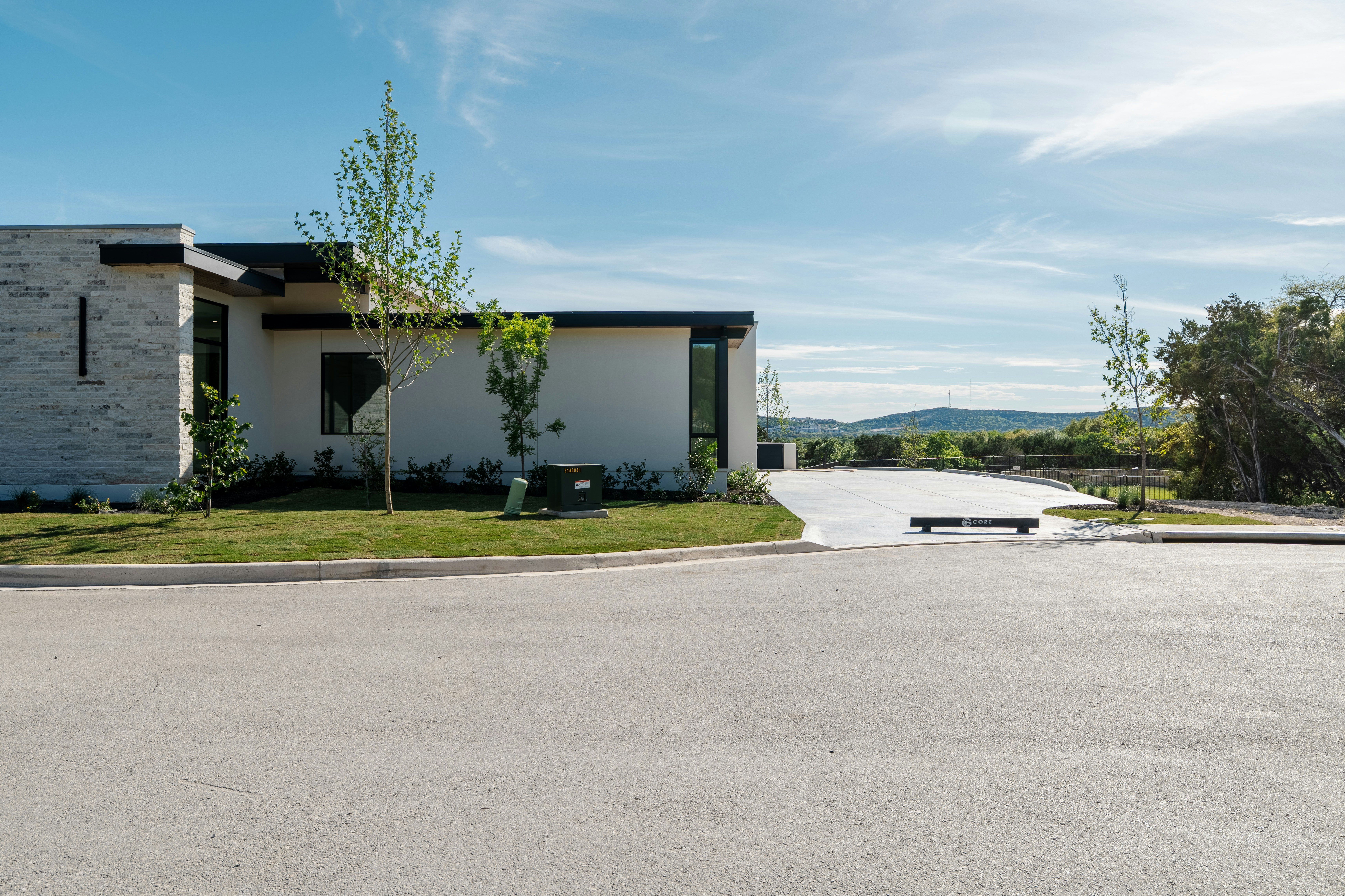 Exterior of a high-end stone masonry estate in Placer County at golden hour featuring a four-car garage and tiered terraces.
