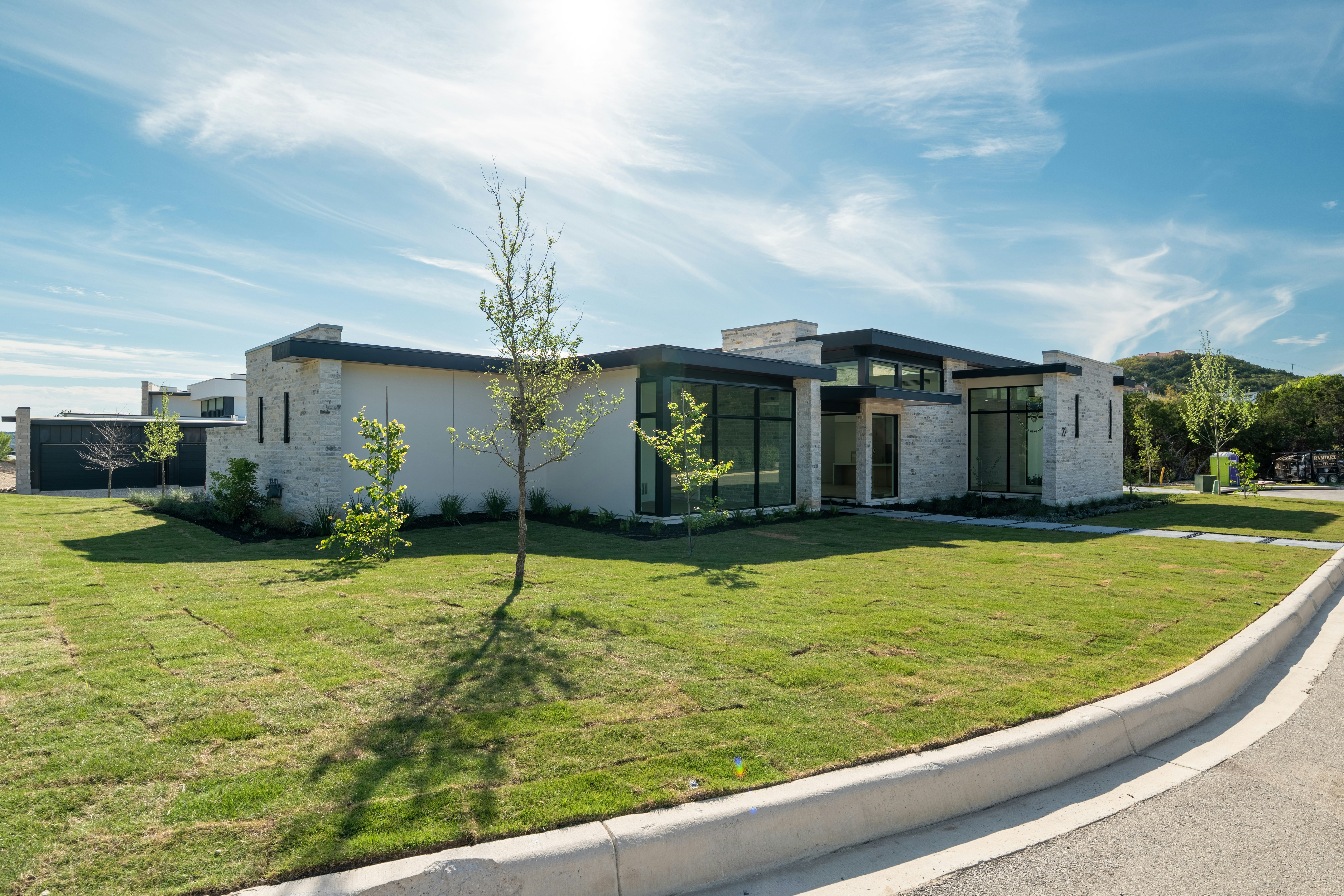 Modern house with a green lawn under a sunny sky