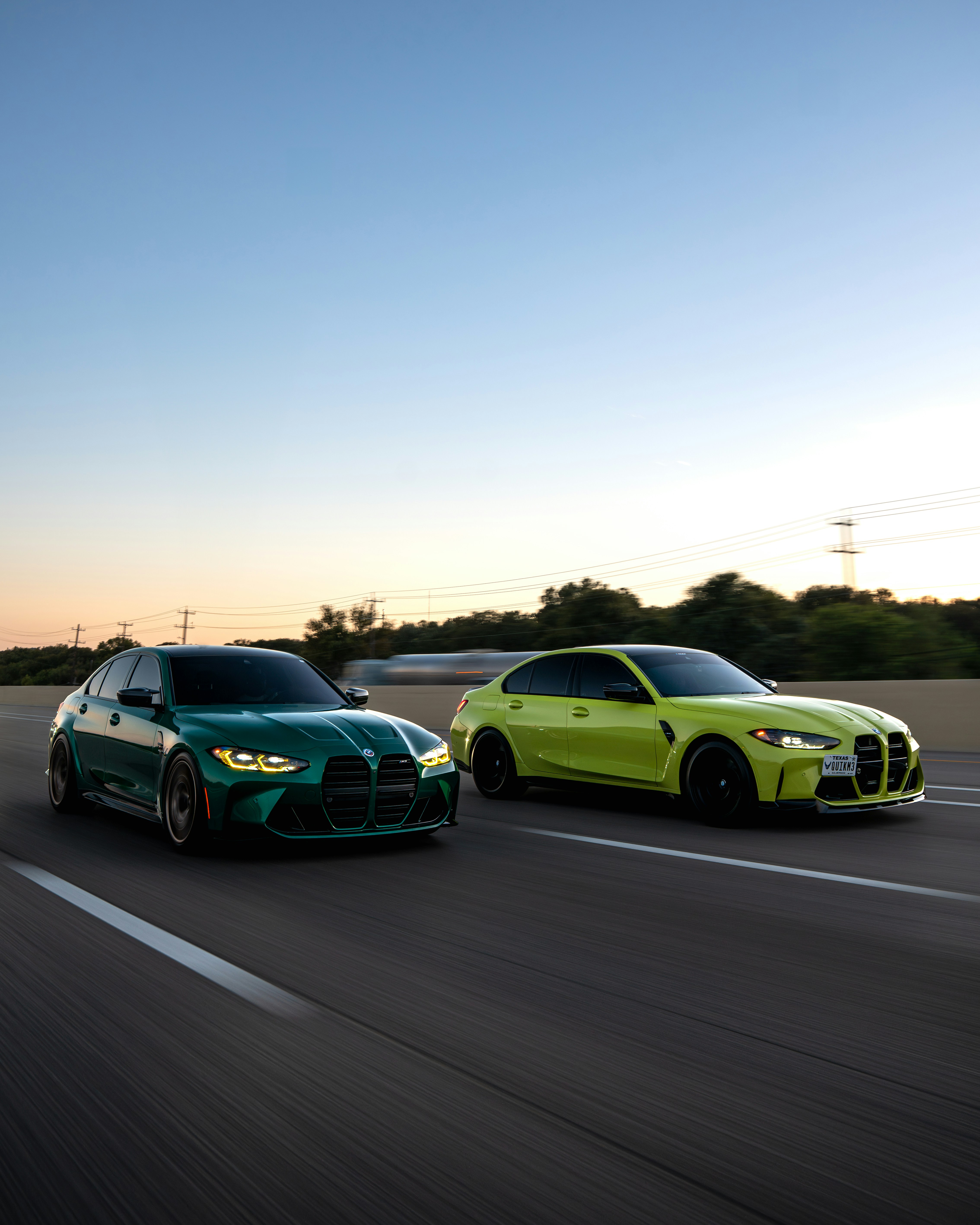 Green and yellow sports cars speeding on a highway