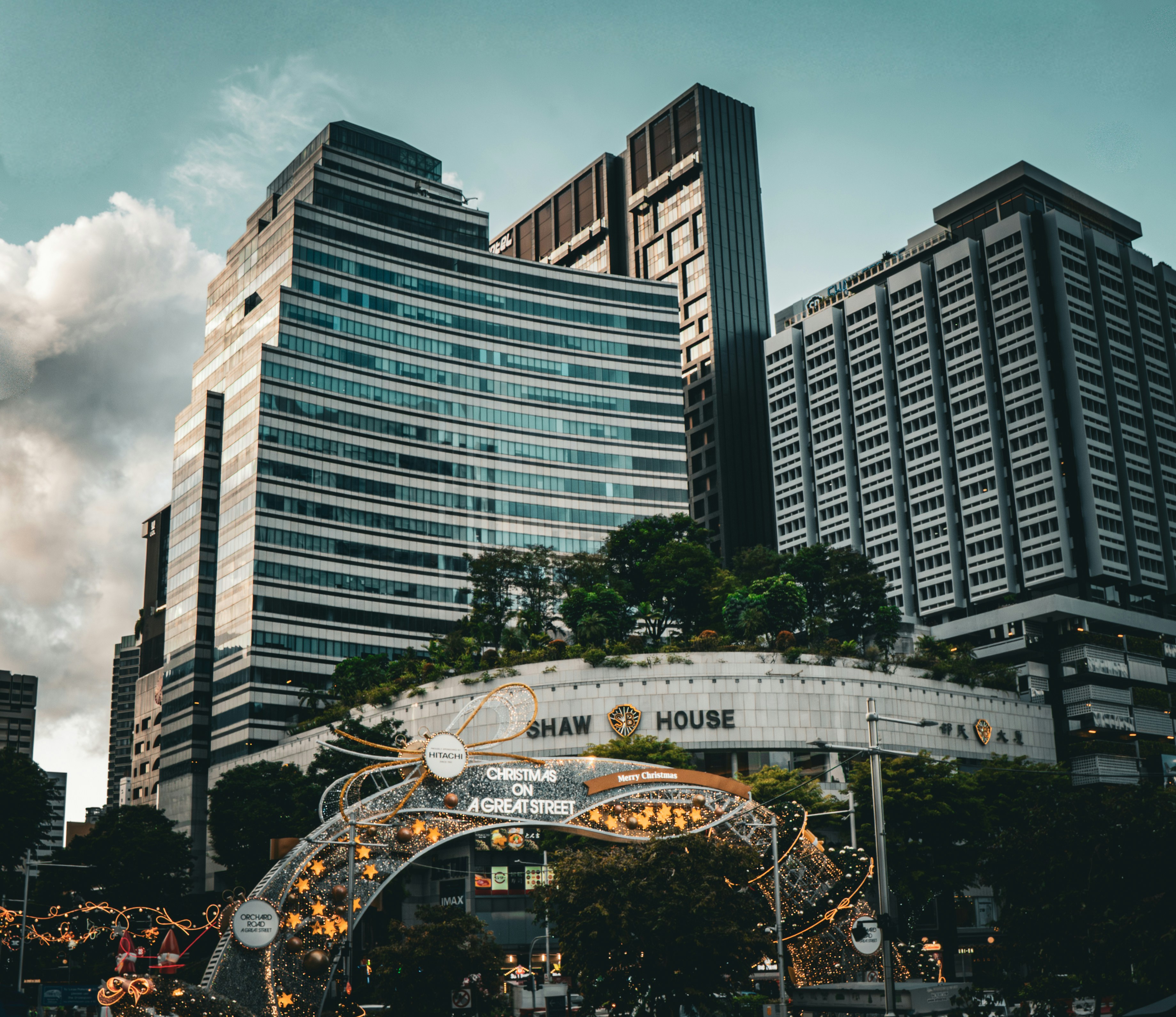 Modern city buildings with an illuminated archway and shaw hous…
