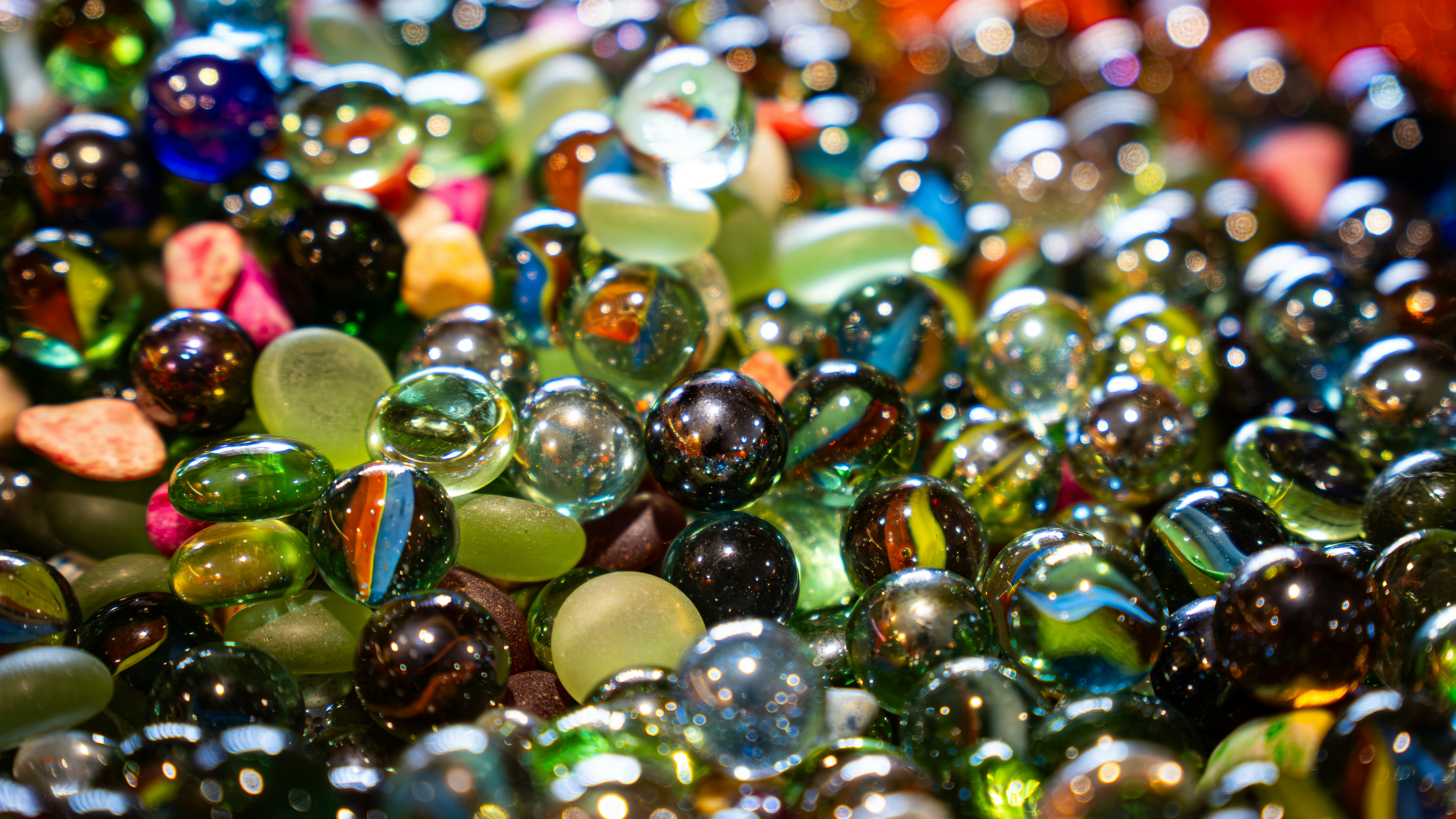 A pile of colorful glass marbles reflecting light